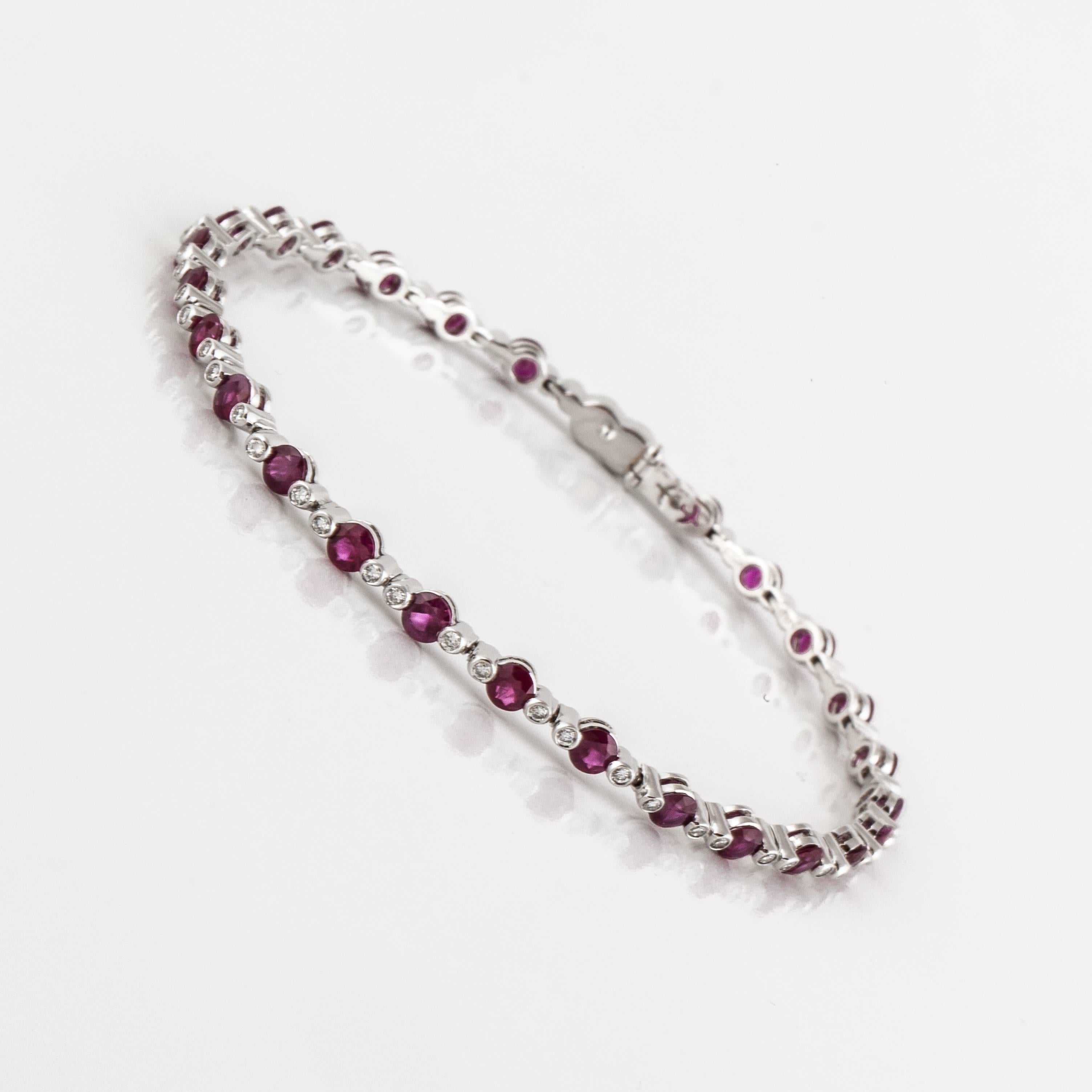 18K white gold line bracelet by Favero featuring rubies and diamonds.  The bracelet contains 26 round rubies totaling 4 carats and 63 round diamonds totaling 0.60 carats; H-I color and VS-SI clarity.  It measures 7.5 inches long and 1/8 of an inch