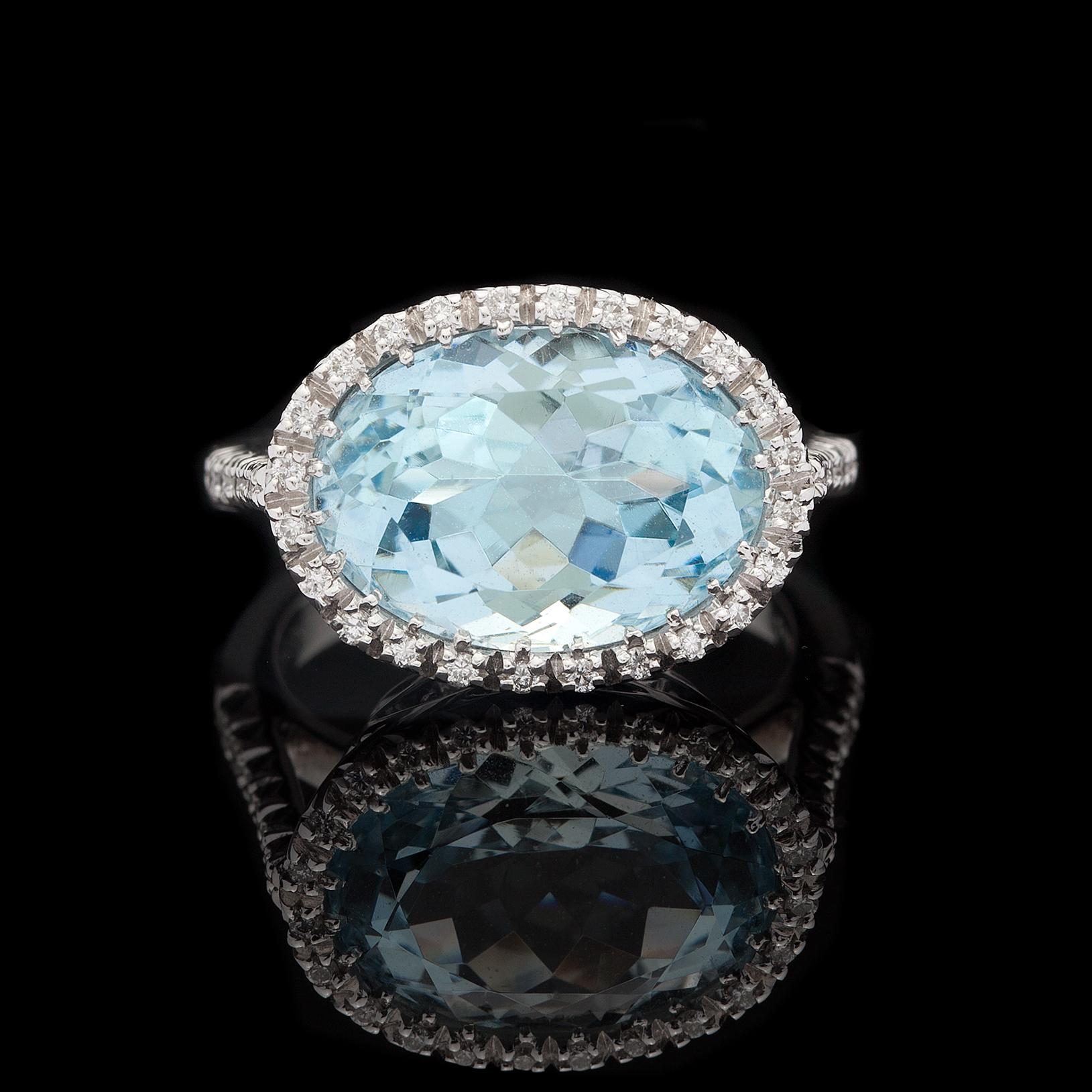 Eye catching Favero 18Kt White Gold Oval Brilliant Cut 6.13ct Aquamarine Ring set with approximately 0.23cts of Round Brilliant Cut Diamonds. A fabulous contemporary design featuring a gorgeous center stone! The total weight of the ring is 7.6 grams