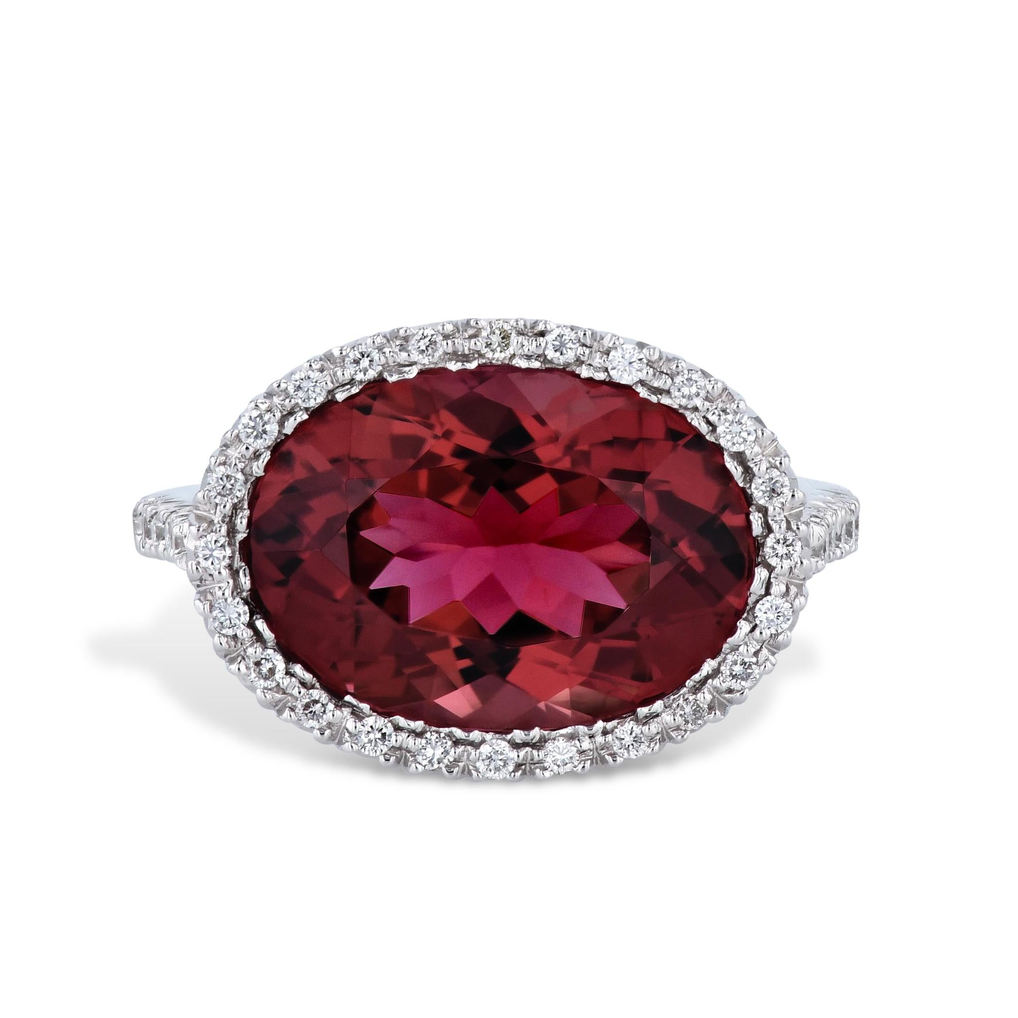 Experience luxury and elegance with the Favero Pink Tourmaline Diamond Estate Ring. Enchanting Oval-cut pink tourmaline at its center, weighing 6.19ct, is prong-set and radiates with brilliance. Surrounding this eye-catching gemstone are pave-set