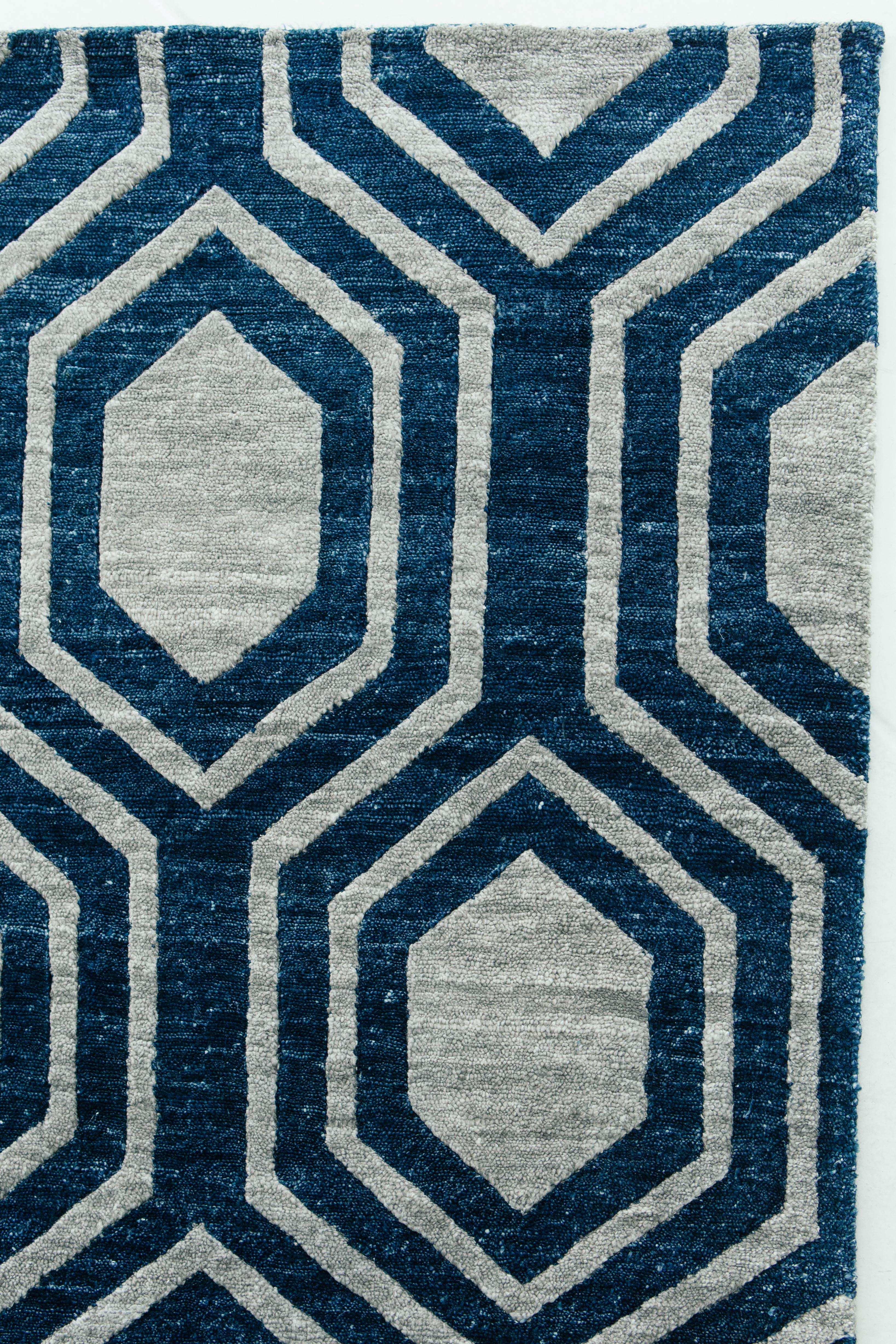 'Favo' is a beautiful cobalt blue and silver bamboo silk rug with a diamond lattice design. This rug from our Elan collection has a true masculine and luxurious essence. 'Favo' will be a showstopper in any setting and will leave lasting