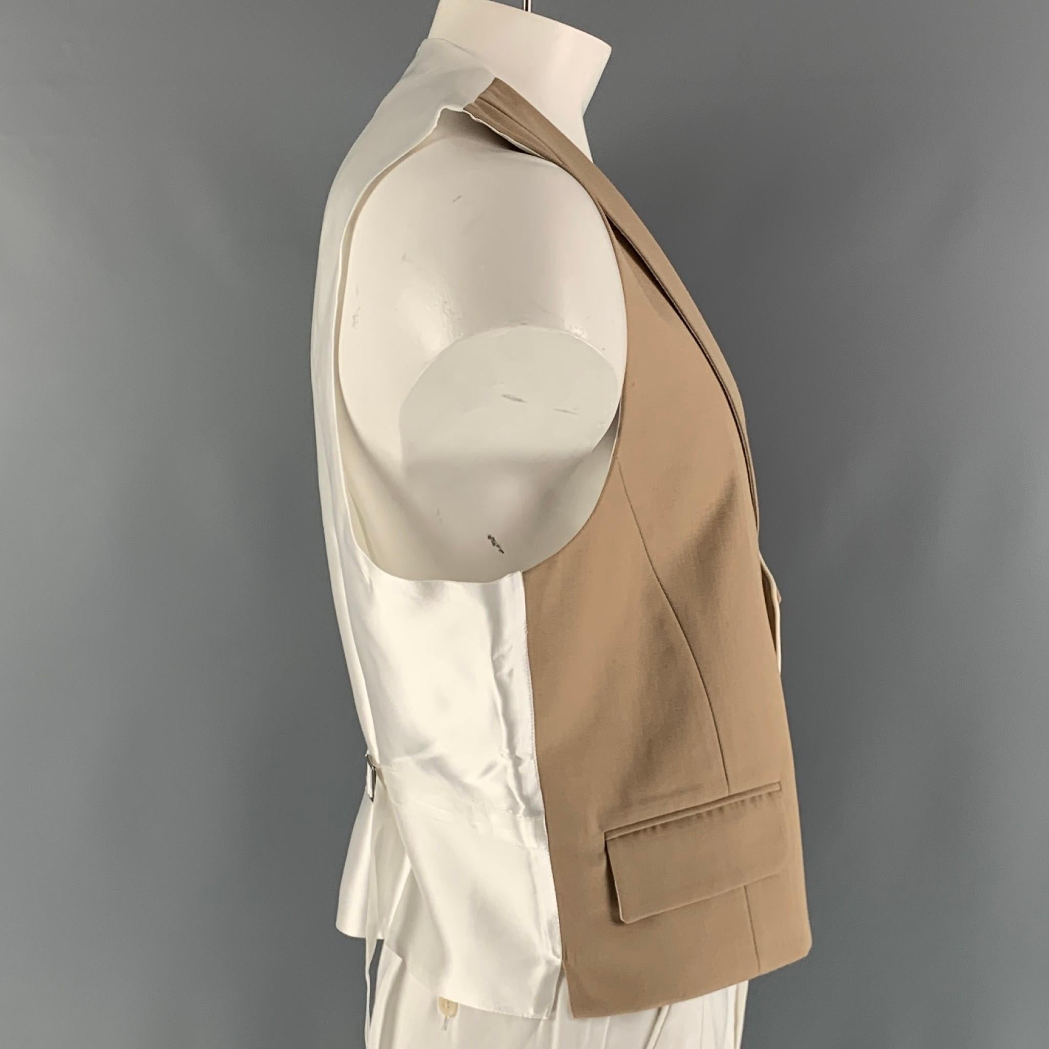 FAVOURBROOK u-neck vest comes in a khaki and white wool woven material featuring a shawl collar, flap pockets, double brest, back belts, and a mother of pearls buttoned closure. Made in England.

Excellent Pre-Owned Condition.
Marked: no size