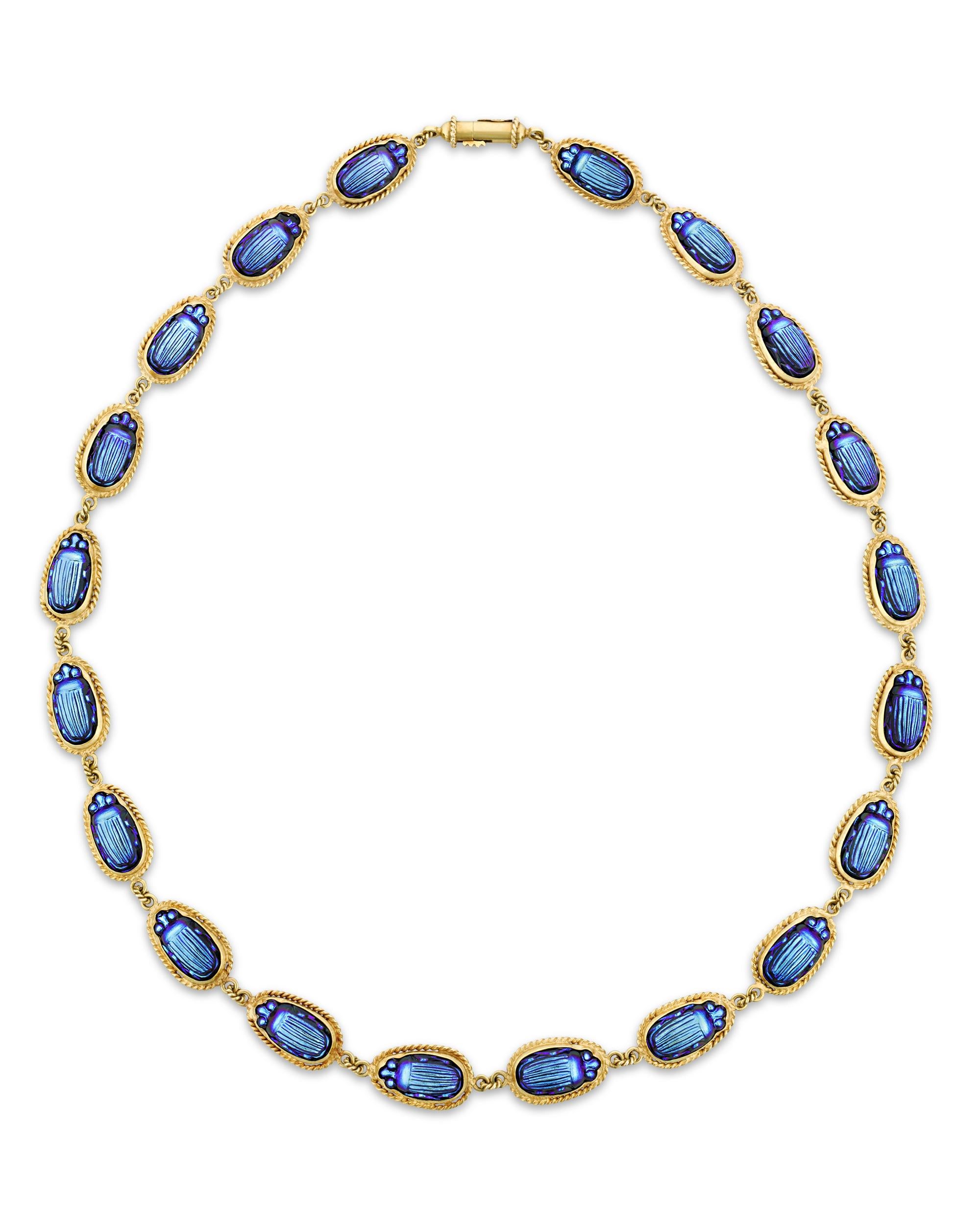 Created by legendary designer and premier tastemaker of the Gilded Age, Louis Comfort Tiffany, this necklace is a rare and unique masterpiece of jewelry design. Delicately crafted, the necklace boasts an Egyptian Revival design inspired by the