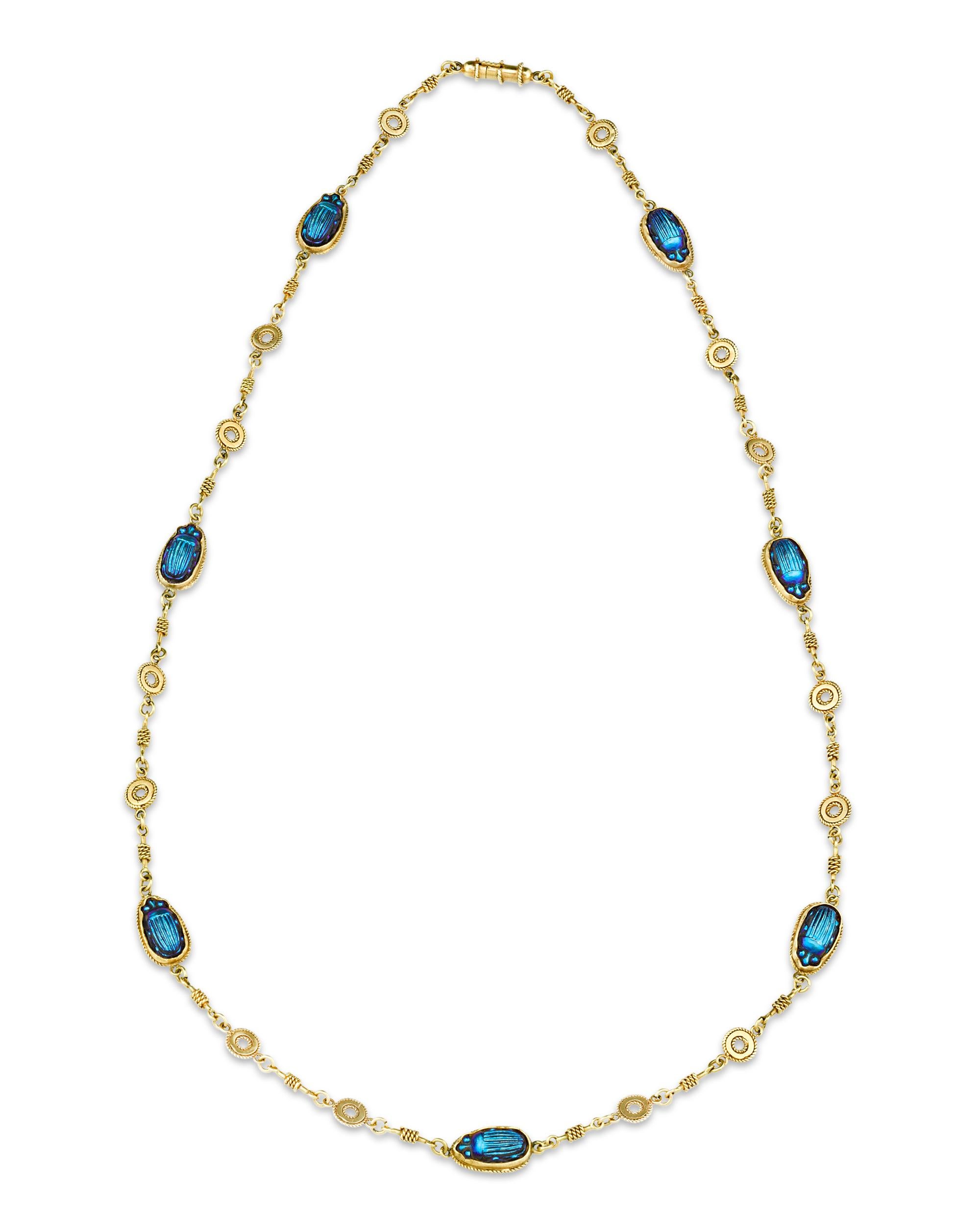 Created by legendary designer and premier tastemaker of the Gilded Age, Louis Comfort Tiffany, this necklace is a rare and unique masterpiece of jewelry design. Delicately crafted, the necklace boasts an Egyptian Revival design inspired by the