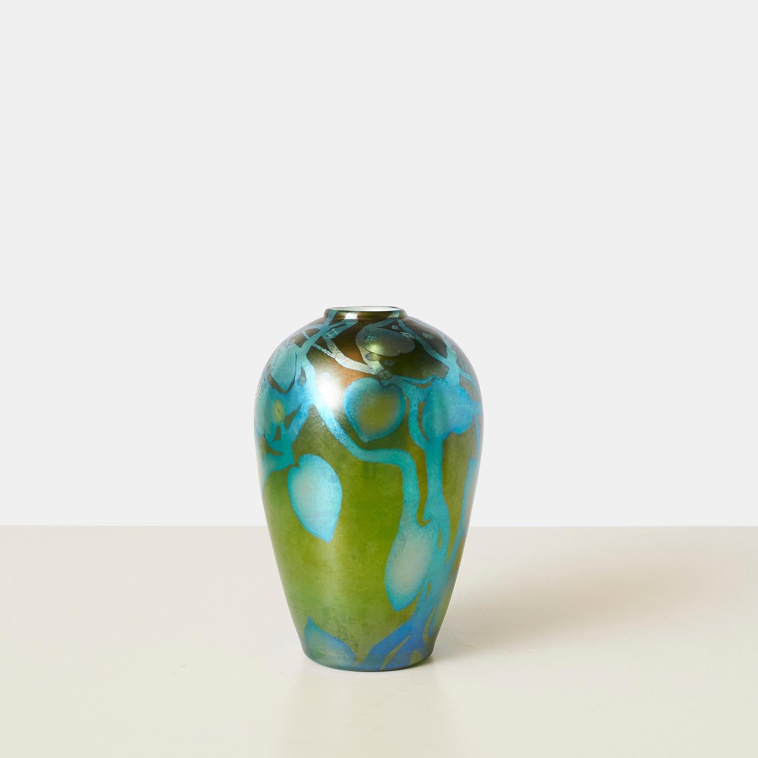 An petite opalescent ovoid favrile glass vase in hues of greens and blues by Louis Comfort Tiffany. Etched J C T and numbered on the base.

No chips, cracks or repairs.