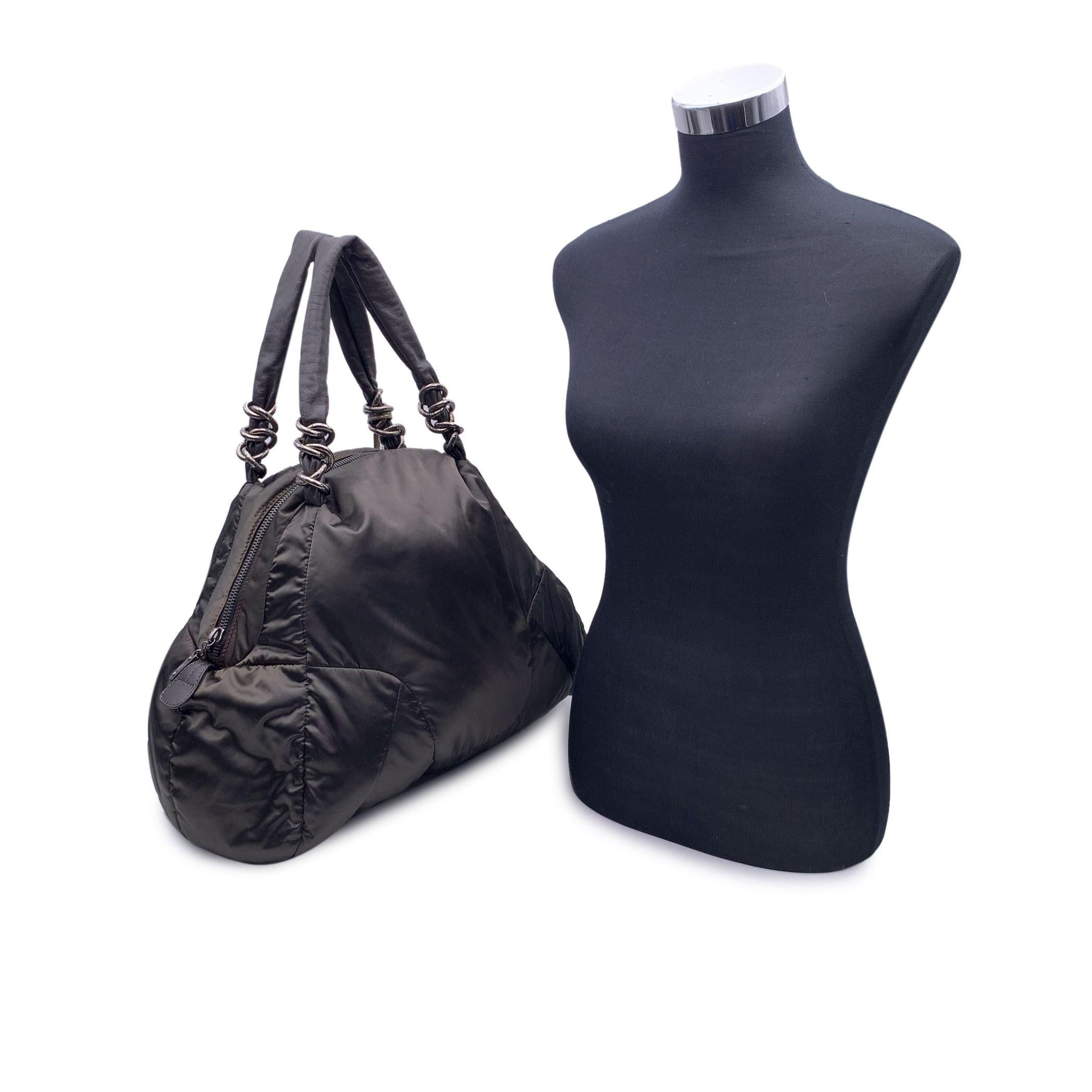 Beautiful Fay puffer tote bag in black nylon. Dark brown leather handles. Silver metal hardware. Upper zipper closure. Beige satin lining. 1 side zip pocket and 1 side open pocket inside. 'Fay' tag inside Condition A - EXCELLENT Gently used.Please