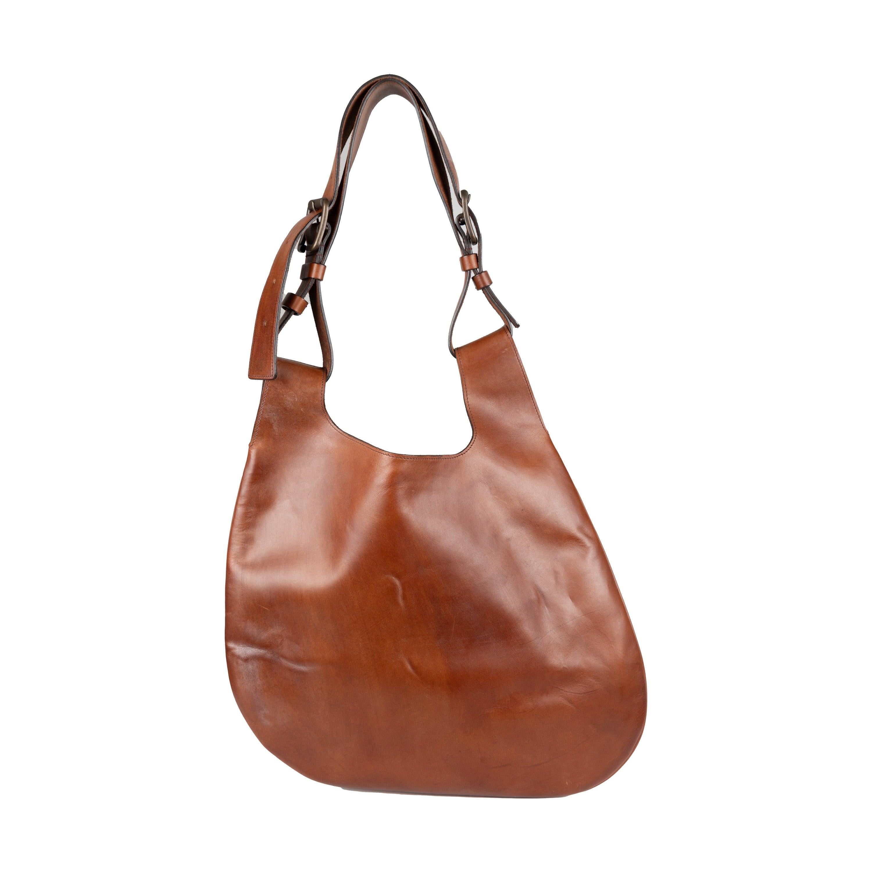 Elevate your look with this unique Fay Leather Hobo Bag. Crafted from supple leather in brown with an asymmetrical design, it features an adjustable double handle and antique metal details. The suede interior offers plenty of storage space and
