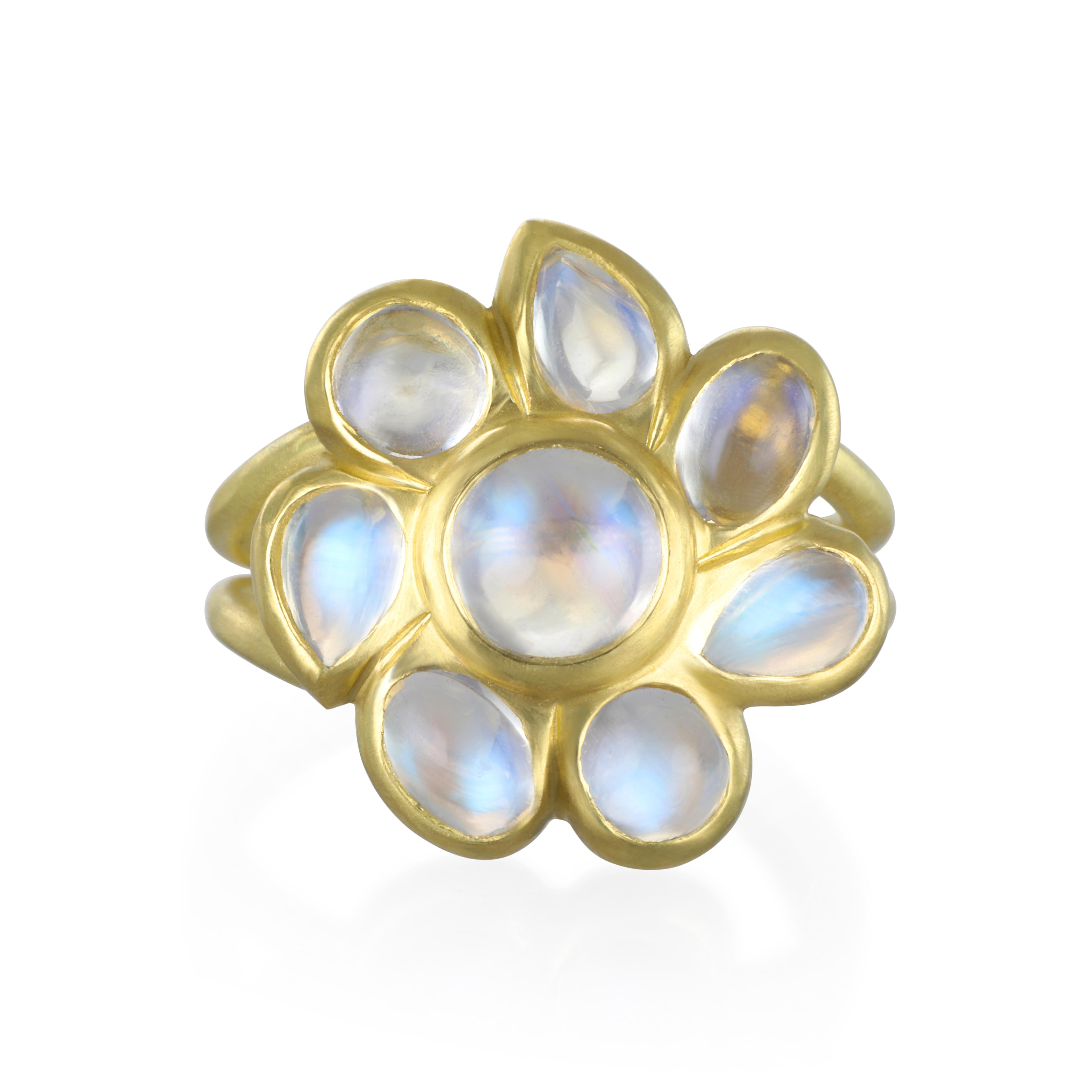 Take a walk on the glamorous side with this Faye Kim Ceylon Blue Moonstone Daisy ring.  Known for its beautiful iridescence, the exciting blue flash adds to the overall mystique surrounding moonstones.  Organic shaped cabochon moonstones are what