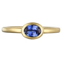 Faye Kim 18 Karat Gold .70 Carat Oval Blue Sapphire Single Stone Bezel Ring