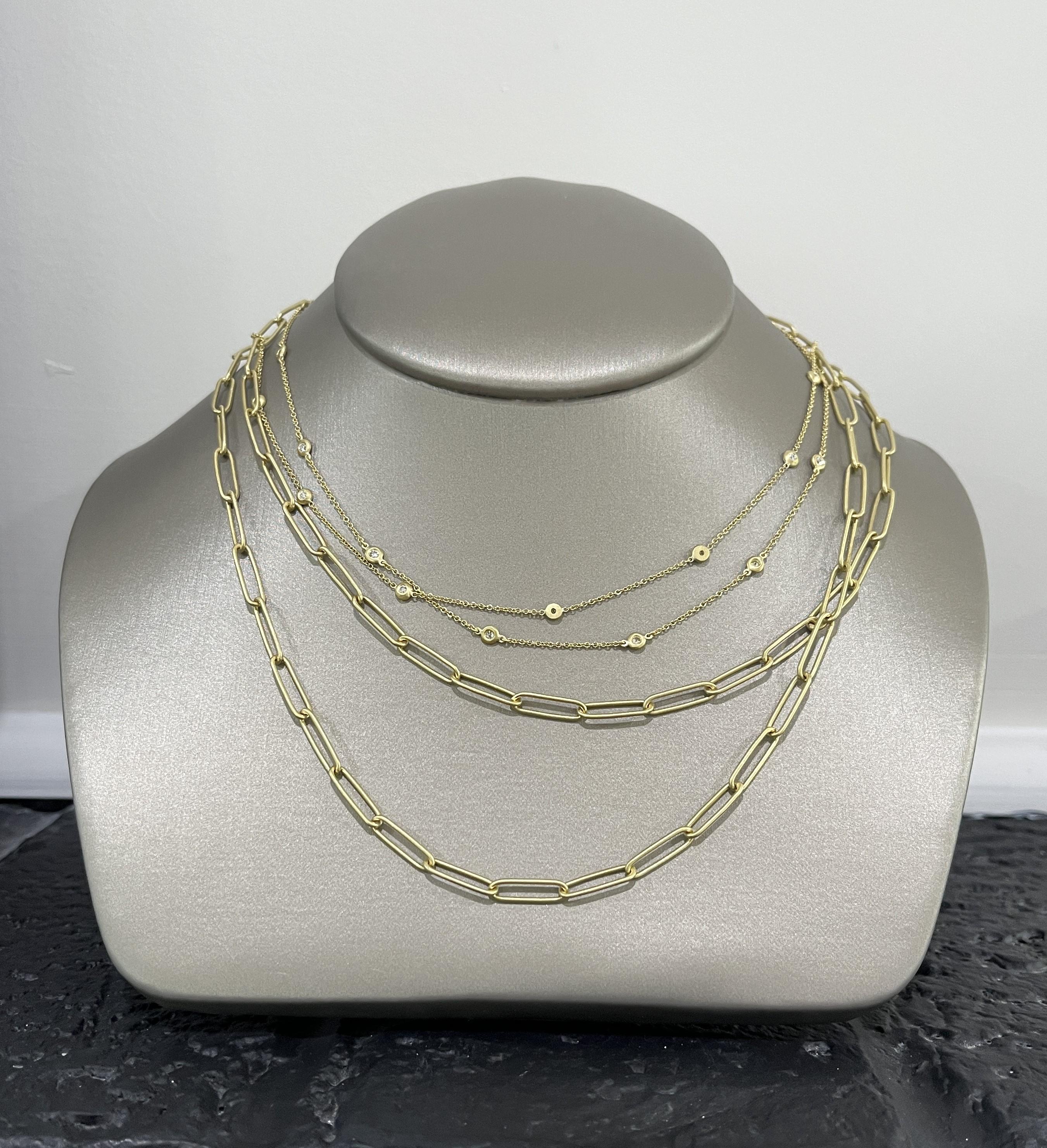 Classic and versatile, Faye's 18 Karat Gold and Diamond Station Necklace is a must  have for every jewelry wardrobe. Its bezel-set diamonds add subtle sparkle and shine to a classic style chain, which can be worn alone or as a layering piece with