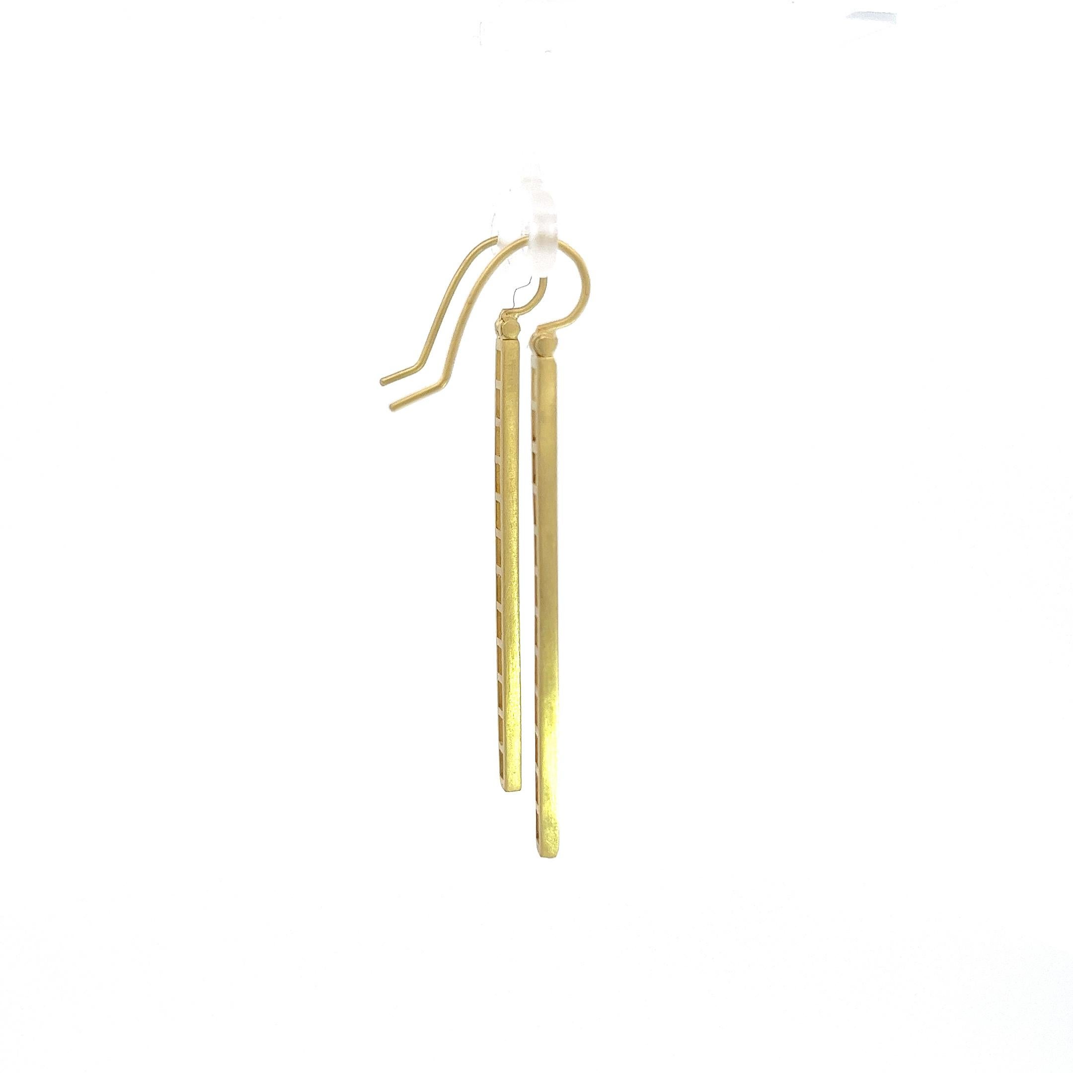 Channel set in 18 karat gold, the diamond baguettes create a sleek, clean line for a chic, contemporary look.
Matte-finished with hinged ear wires for movement. 

Diamonds: E/F, VS Quality 2.68 TCW
Length: 2.17 
