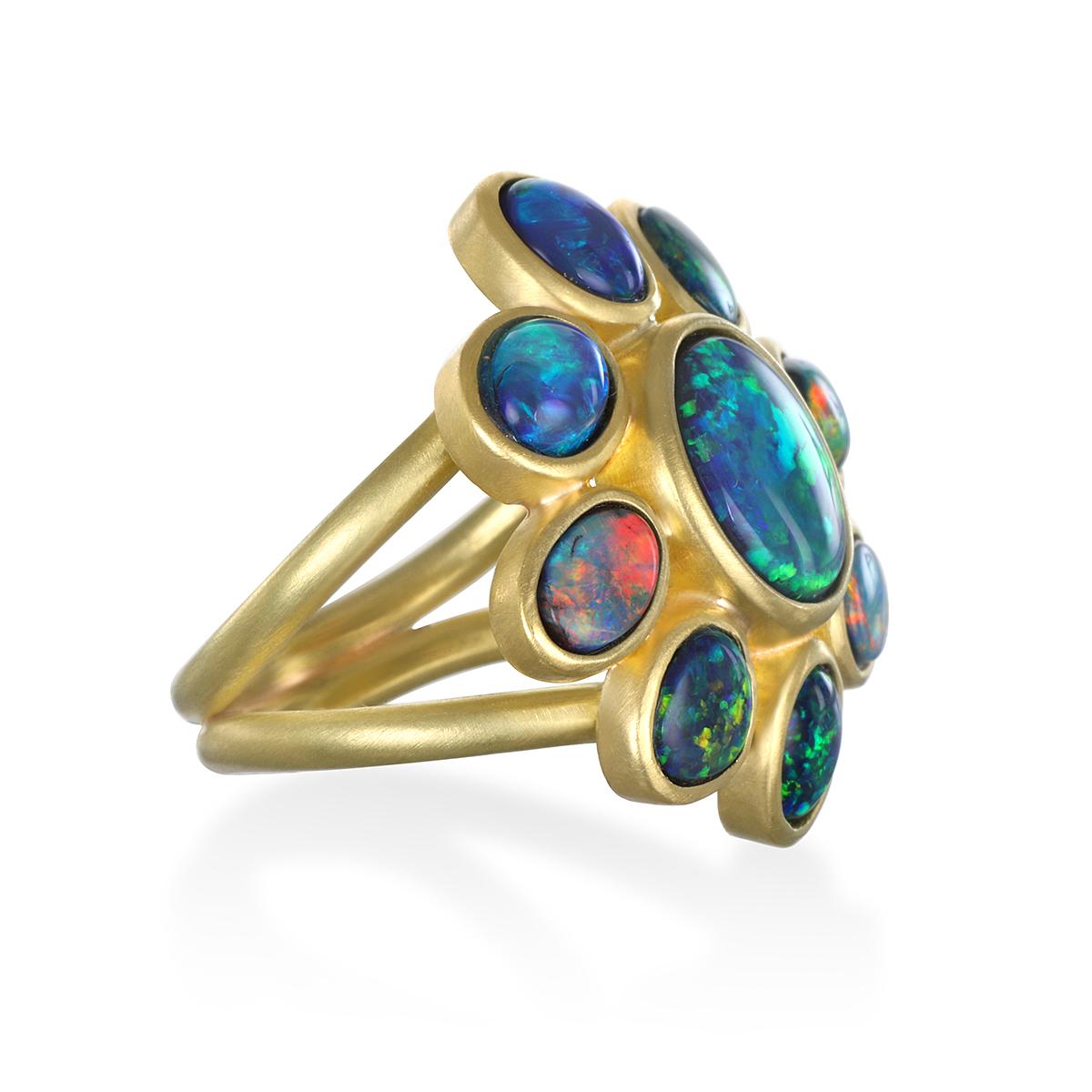 From Lightning Ridge, Australia, a one-of-a-kind collection of black opals comprises Faye's spectacular 18k Gold Daisy Ring with a split shank.

Opals 6.85 tcw
(Center opal 2.72 cts/105 x 9mm)

L x W = 1