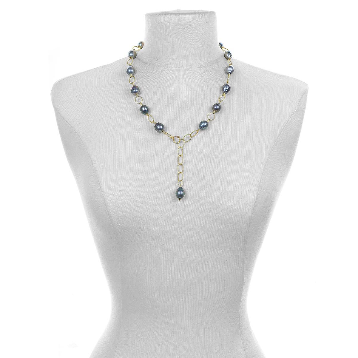 Faye Kim's 18 Karat Gold Black Tahitian Pearl Necklace is interspersed with gold links to give it lightness. Shown as a lariat in photos but can be worn without the lariat. Can also be layered with other necklaces and pendants or worn as a triple