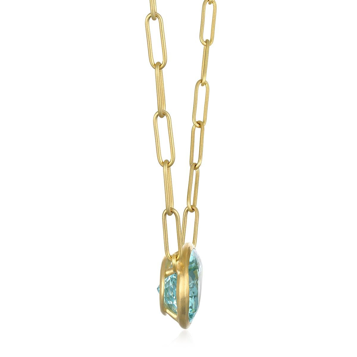 Faye Kim's spectacular 18 Karat Gold Pear Shaped Beryl Necklace, with its mesmerizing blue-green color and open bezel, is suspended on the designer's signature matte finished paperclip chain necklace. This one of a kind statement piece will