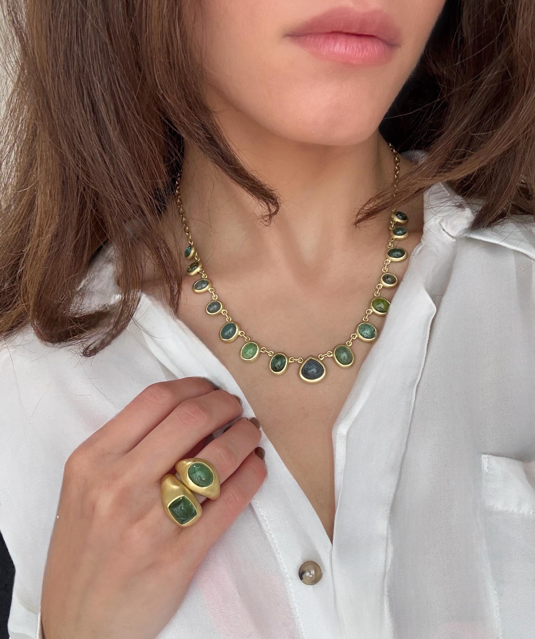 Faye Kim's one-of-a-kind 18k Gold Blue-Green Tourmaline Cabochon Necklace blends modern design with understated elegance. A series of striking graduated bezel-set oval tourmalines - in varying shades of blue-green and green - leads to a spectacular