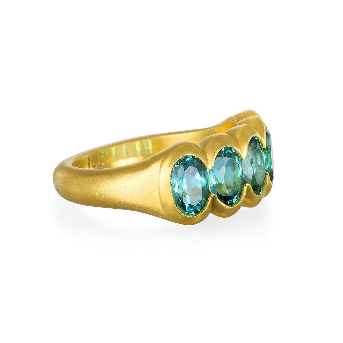 Faye Kim's one of a kind 18 Karat Gold Blue-Green Tourmaline Scallop Ring evokes a feeling of nostalgia yet feels both timeless and modern in its matte finish setting. The ring is a statement piece, and would complement any wardrobe...perfect for