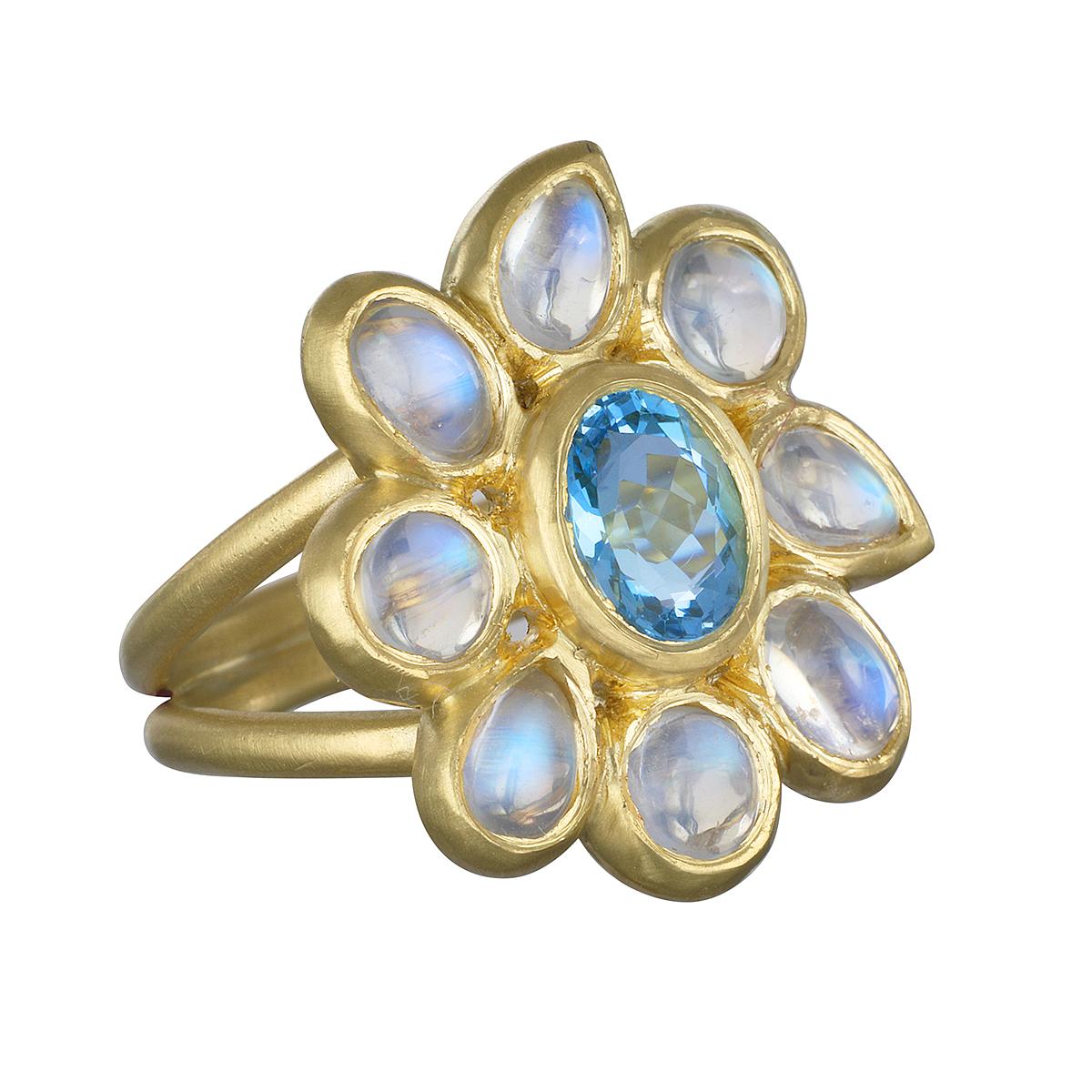 One of a Kind and Unique, Faye Kim's Ceylon Blue Moonstone Daisy Ring features a beautiful blue Aquamarine center.  Known for its beautiful adularescence, the blue flash adds to the overall mystique surrounding moonstones. 

Model is photographed