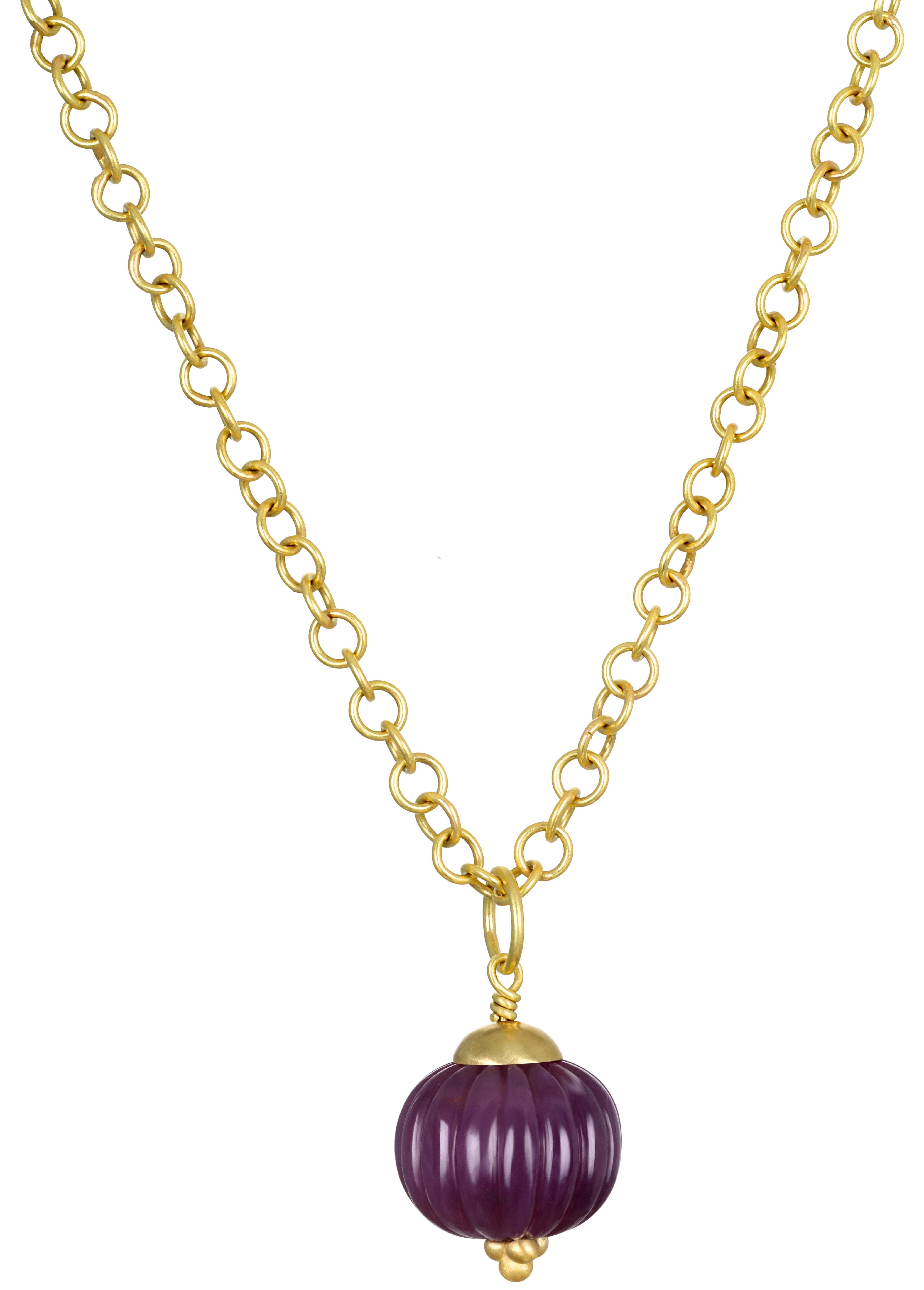 
Faye Kim's 18K Gold Carved Natural Ruby Bead Pendant with Granulation Detail features a stunning magenta-hued orb. This unique piece stands out with its distinctive texture and scale, making it a perfect complement to a variety of chains from our
