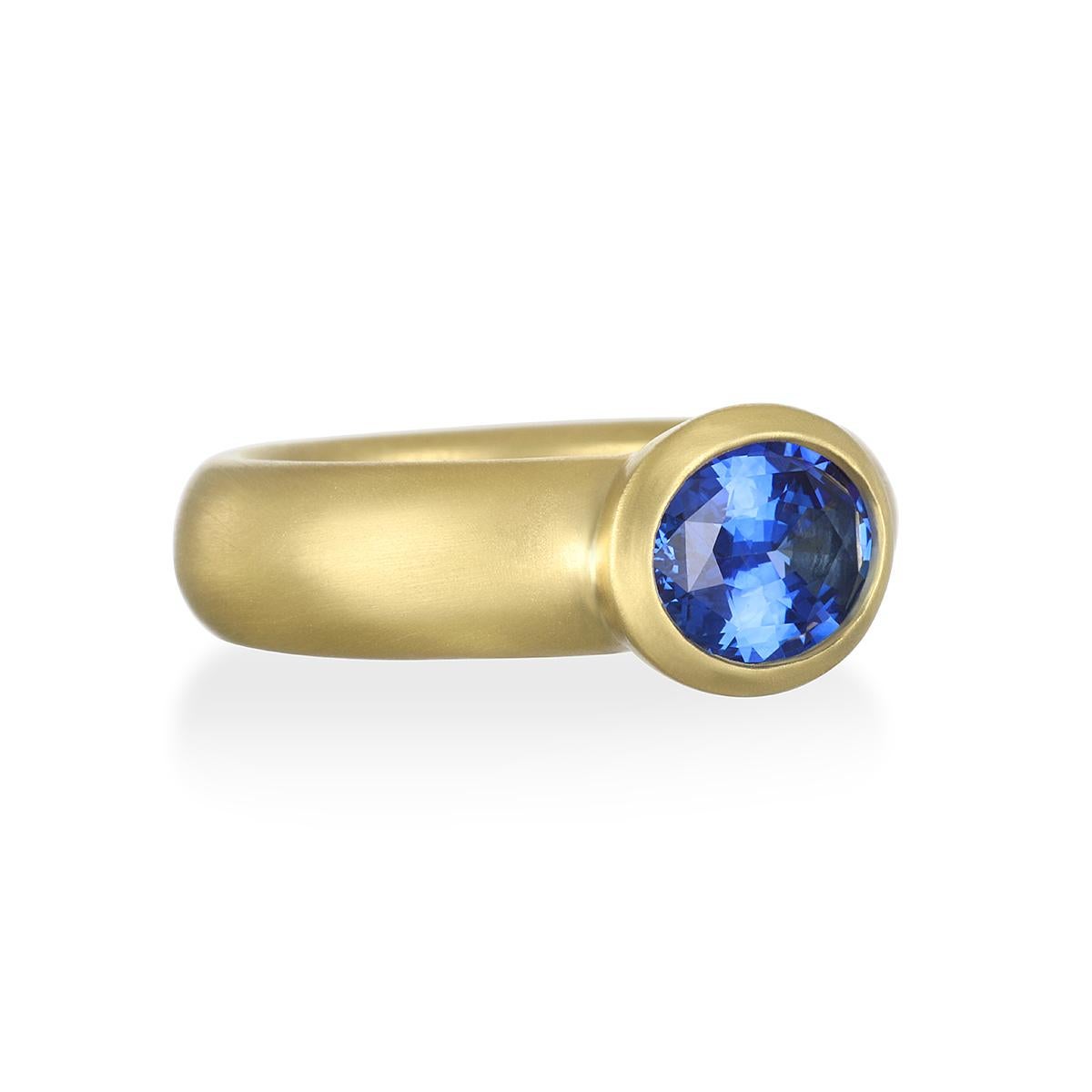 A beautiful, vivid shade of blue, this Sapphire ring is bezel set in 18K gold* with a matte finish for a clean, timeless look. It can be worn alone as a statement piece or stacked with other rings. Model pictured wearing similar style