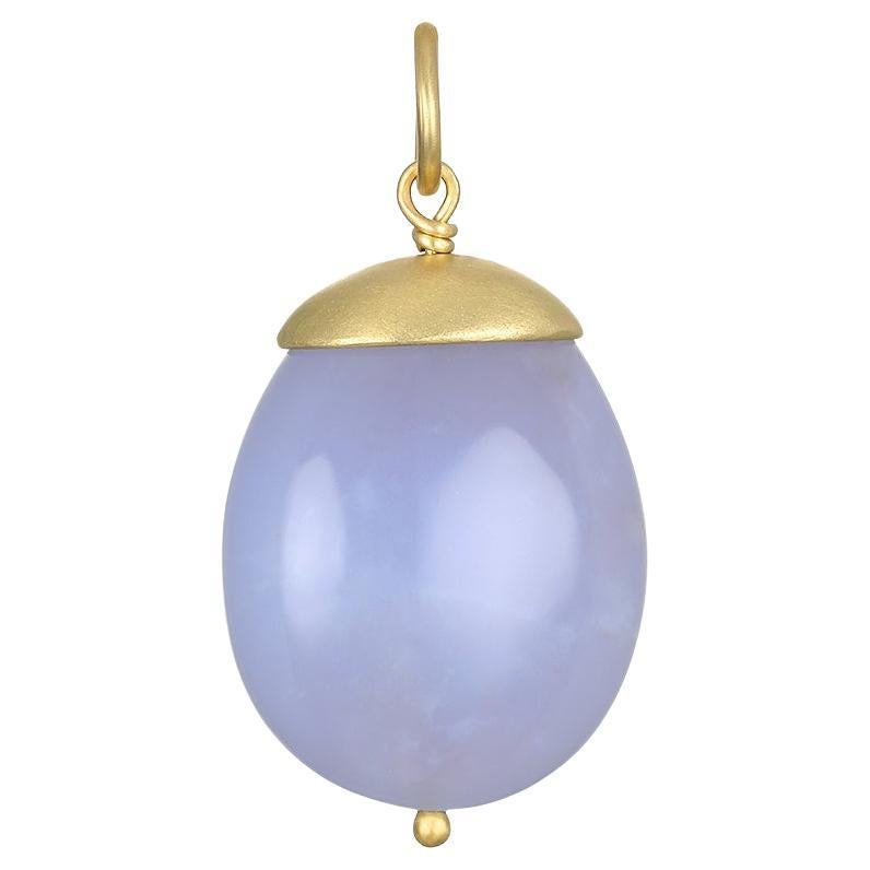 Faye Kim's 18 Karat Gold Chalcedony Nugget Pendant, with its translucent grayish-blue hue, is sure to make a design statement! This unique, one of a kind piece is finished with Faye's signature gold cap and bead. 

Pendant paired with 18 Karat Gold