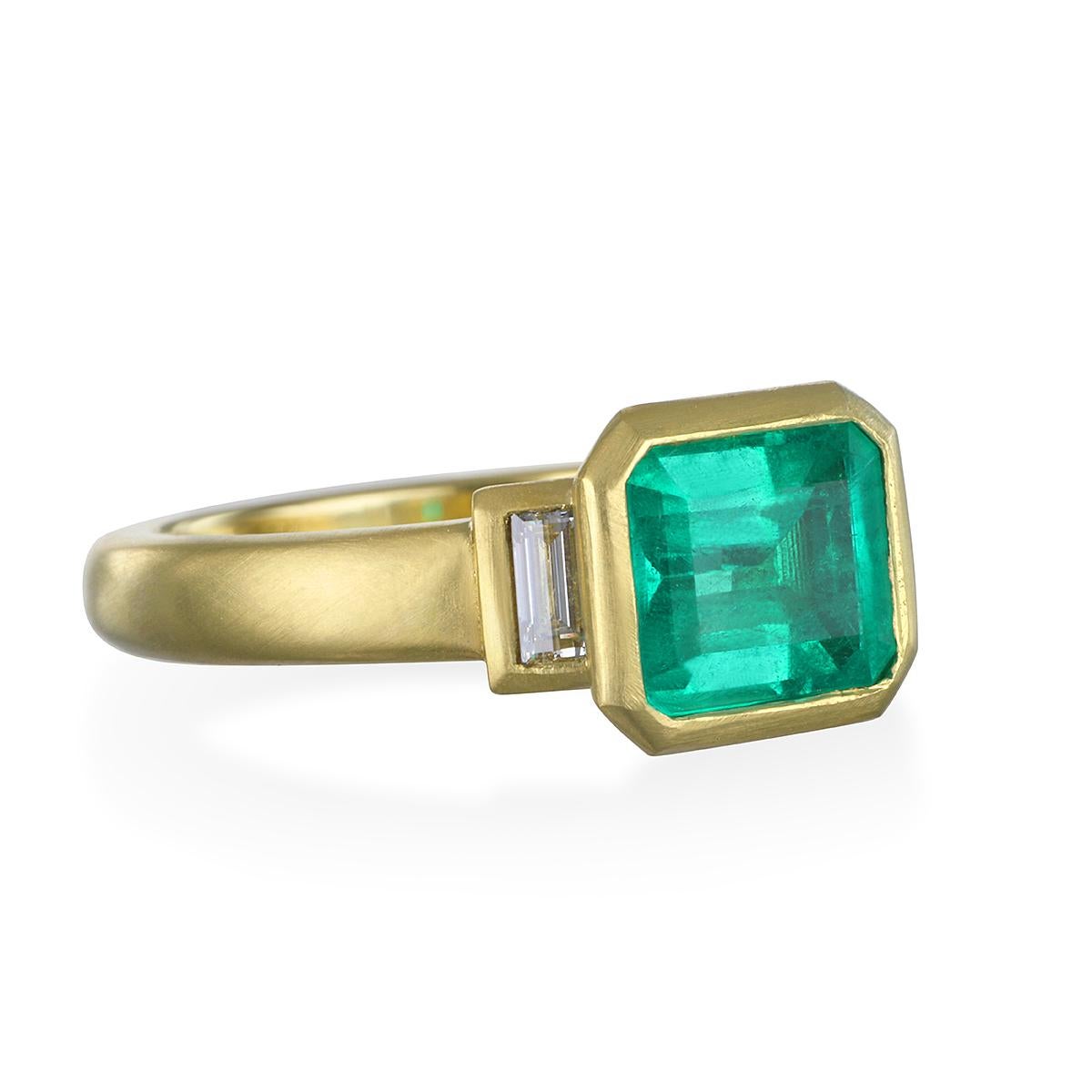 Colombian Emerald flanked by diamond baguettes. The lively green hue is enhanced by Faye Kim's signature 18k matte-finished gold and the sparkle from the side diamonds.

Colombian Emerald - 1.60 Carats
Diamonds - .23 Carats twt
Size 7 
LxW - 9.87 x