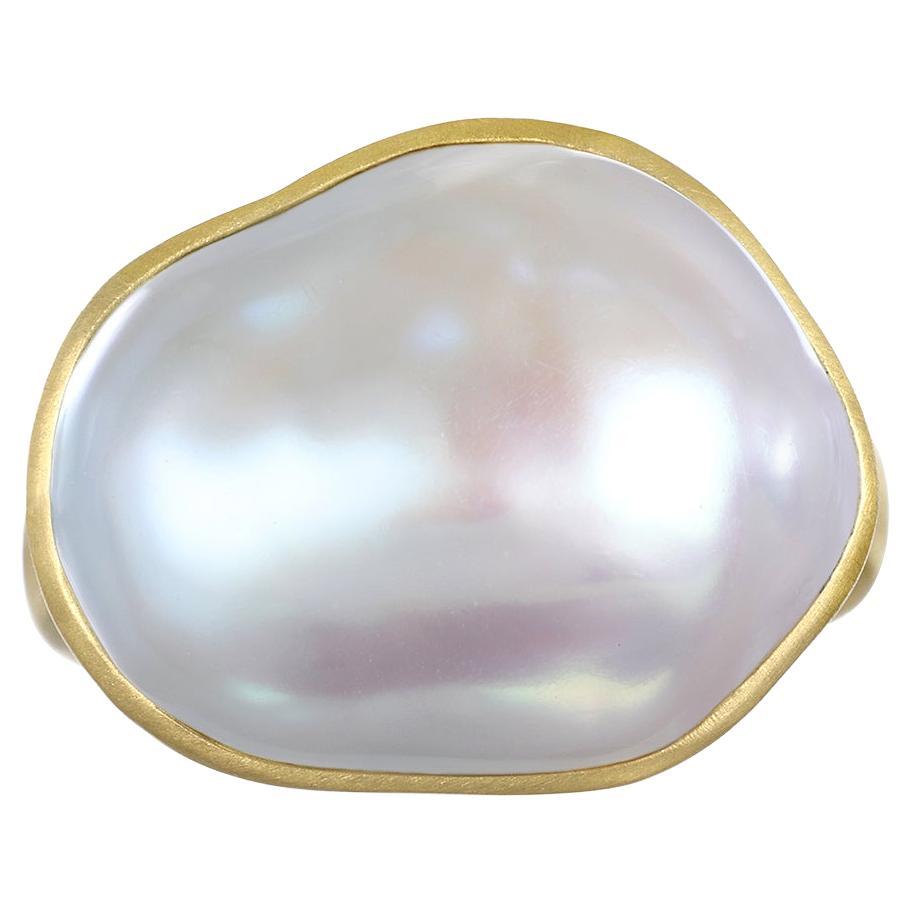 Faye Kim's 18 Karat Gold Cream Baroque Freshwater Pearl Ring is bezel set and highlights the classic beauty of pearls made wearable for today's contemporary styles.

Pearl: 17.5mm
Size: 7.5(Can be resized)

Photos show variations on ring, all sold