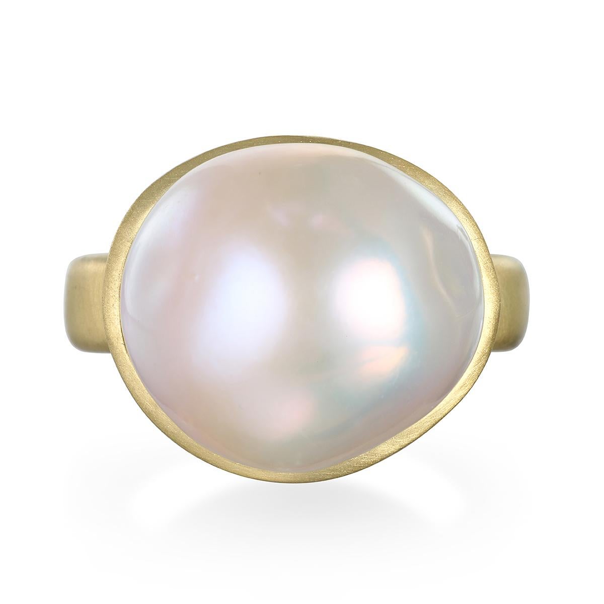 Faye Kim's 18 Karat Gold Cream Baroque Freshwater Pearl Ring is bezel set and highlights the classic beauty of pearls made wearable for today's contemporary styles.

Pearl: 17.5mm
Size: 7.5 (Can be resized)

Photos show variations on ring, all sold