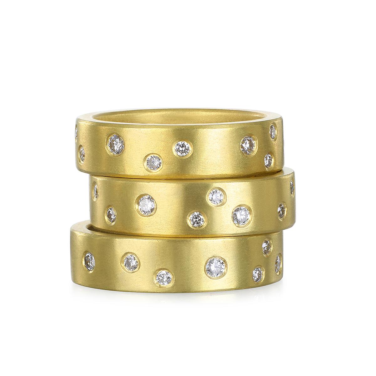 Crafted from solid 18 Karat Gold, Faye Kim's Diamond Burnished Band Ring sparkles with the brilliance of the night sky. This versatile ring can be worn alone, as a wedding band, or stacked with other rings for a fresh, modern look.

Diamonds .40