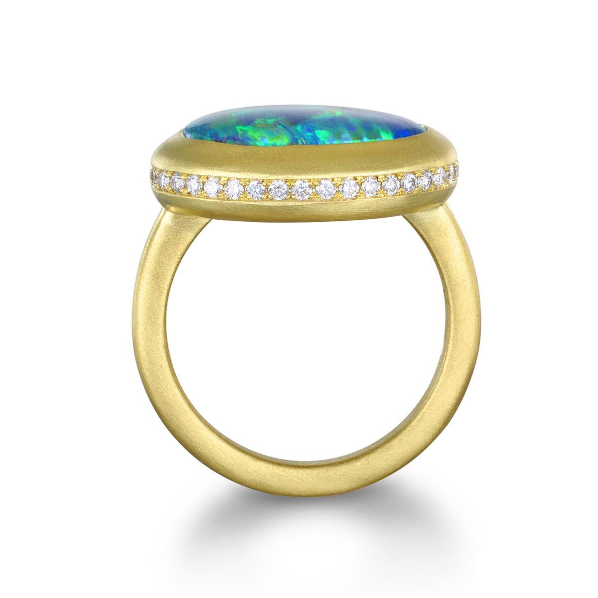 Faye Kim's striking 18 Karat Gold Diamond Halo Lightning Ridge Australian Black Opal Ring marries classic and modern style. The opal's spectacular hue is complemented by its lovely diamond halo and matte-finished bezel setting, while the diamond
