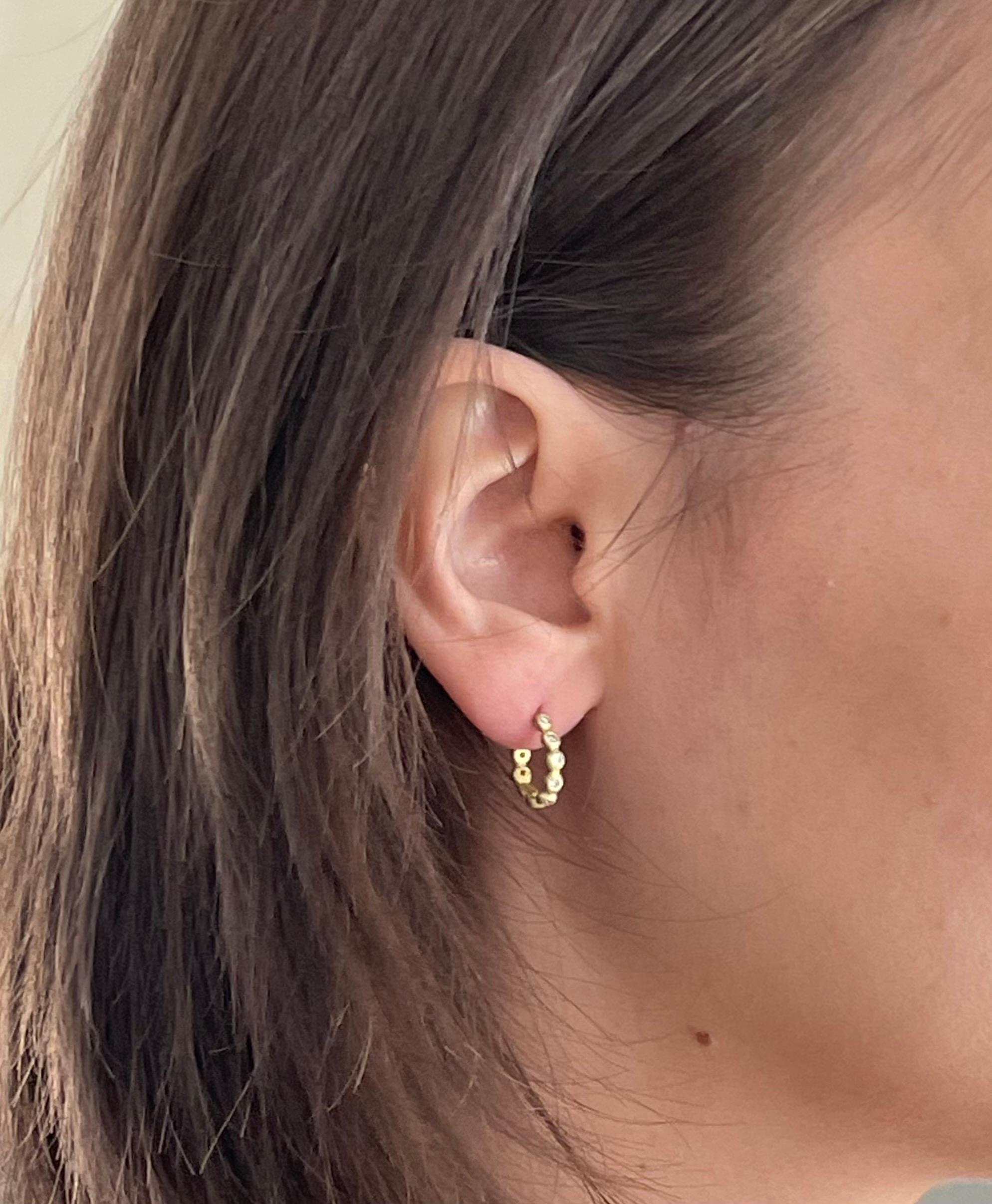 Handcrafted in 18k gold*, Faye Kim’s modern granulation hoop design is a go to everyday look! The signature matte finish enhances the bright sparkle of the diamonds and conveys understated elegance. 

Diamonds = .27 cts twt
3/8