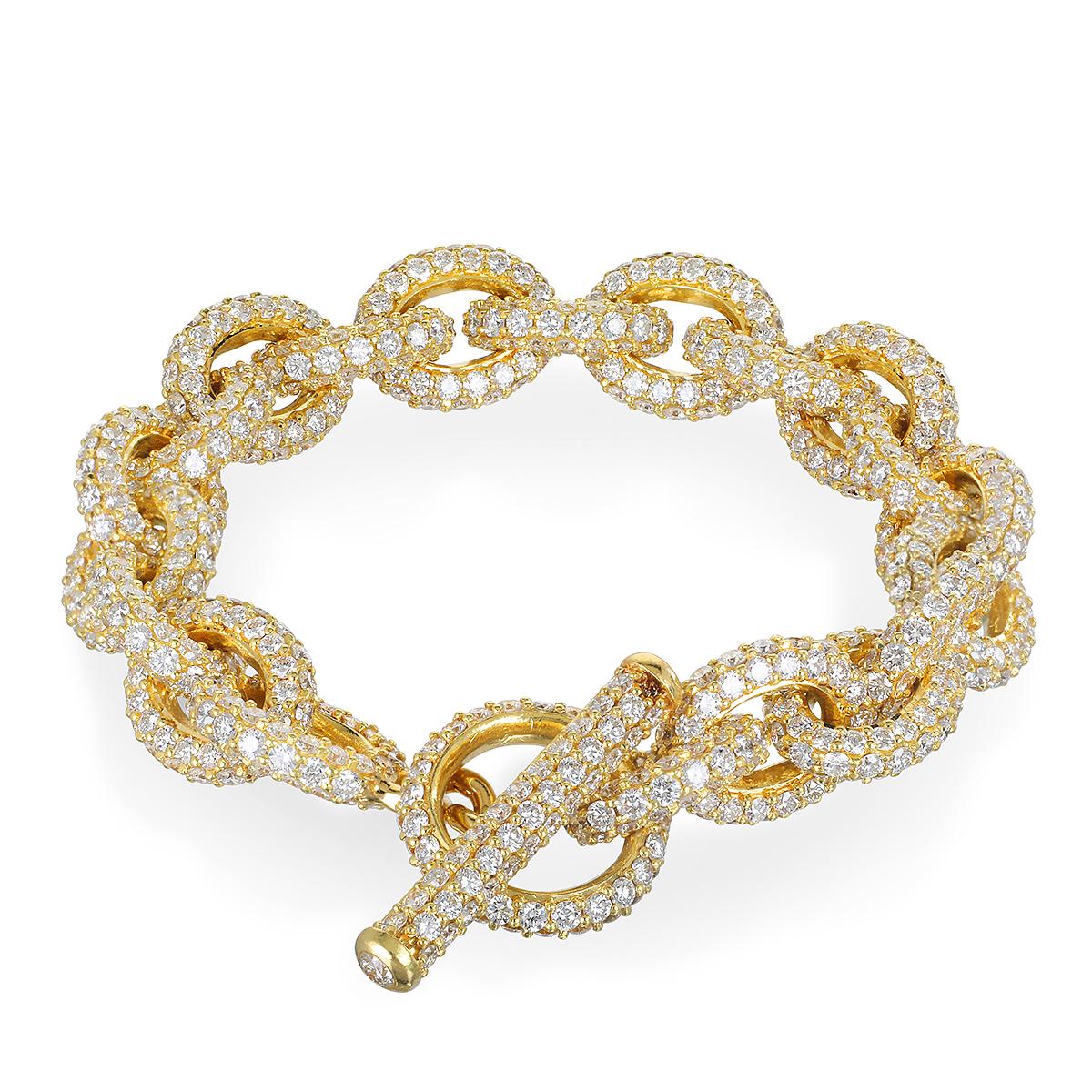 Faye Kim's 18 Karat Gold Diamond Link Bracelet with Toggle Closure is a stunner! Substantial handmade oval links and toggle are fully embellished with round, brilliant cut diamonds, providing sparkle from every angle. Diamonds combined with gold