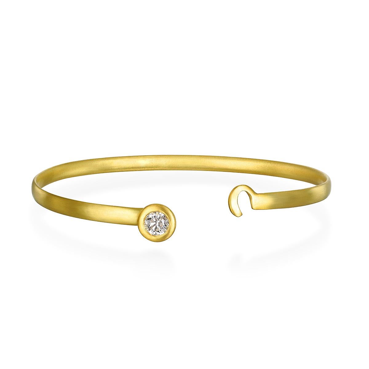 Simply beautiful, this Faye Kim 18 Karat Gold Diamond Solitaire Button Bangle is handmade and oval in shape for a more snug fit. The bright white round brilliant-cut diamond sparkles against the bangle's matte finish. Perfect for wearing alone or