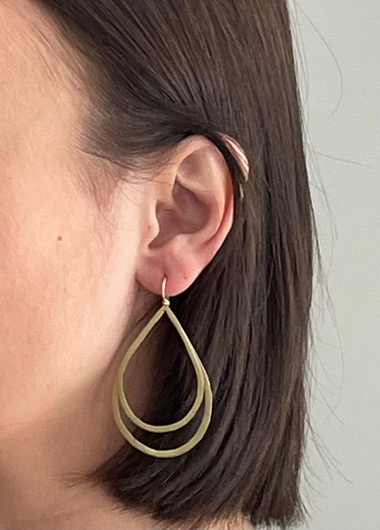 Faye Kim 18 Karat Gold* Double Planished Teardrop Earrings with hinged ear wires. These lightweight earrings are perfect for everyday wear, from office to evening to Sunday brunch.

*In Faye Kim's signature 18k green gold, an alloy comprising 75%