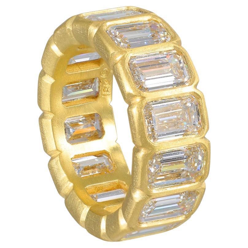 Faye Kim's stunning 18 Karat Gold Emerald Cut Diamond Eternity Band is both timeless and modern. Perfectly matched stones, with its bezel-set emerald-cut diamonds that feature large step facets and high crowns, produce a spectacular brilliance. With