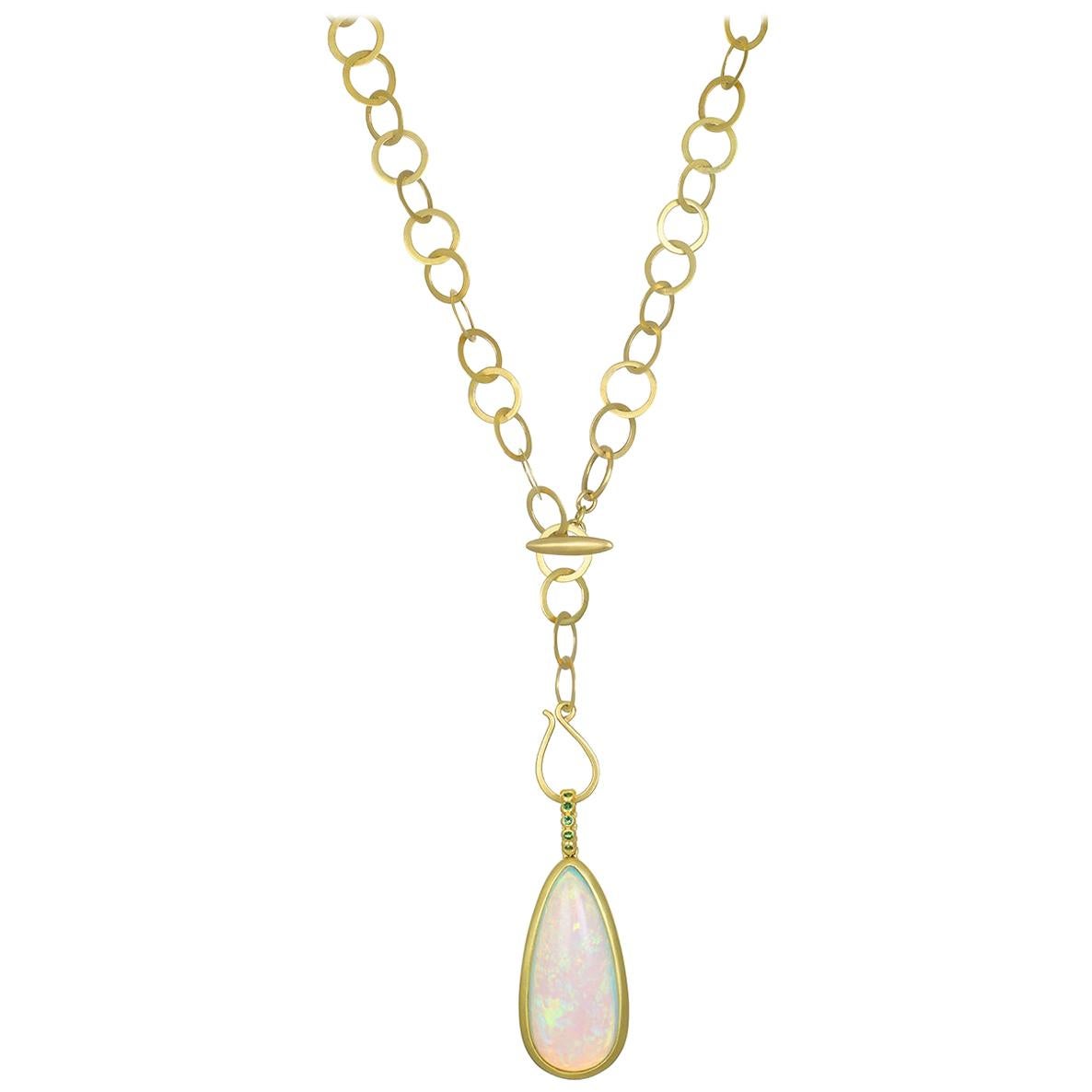 One-of-a-kind Ethiopian Opal and Tsavorite pendant.  The handmade setting is in 18k gold 
featuring  35.03-carat pear-shaped Opal and a granulation bail with bright green Tsavorite Garnets.  Incredible color in a one-of-a-kind, unique setting. The