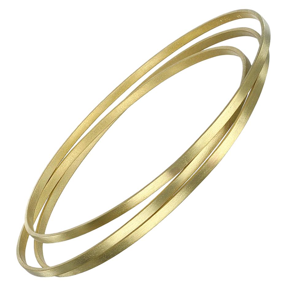Faye Kim's classic bangles handmade in 18 karat gold with a matte finish. Great for stacking or wearing alone for a clean, minimalist look. 

Bangles are sold individually; models shown wearing similar style bracelets, all sold