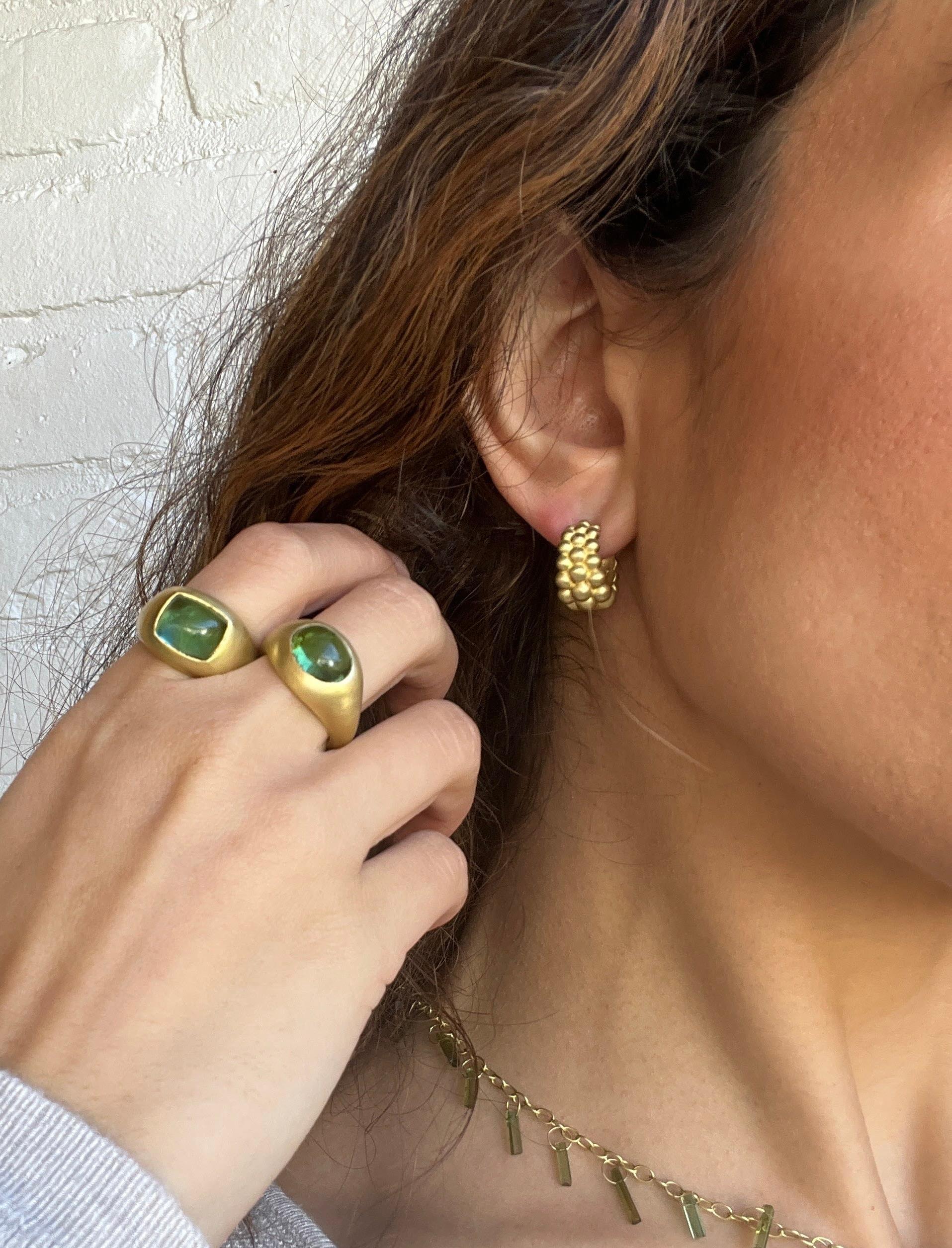 Handcrafted in 18 karat gold, Faye Kim’s modern granulation huggy hoops, with their triple rows of beads and matte finish, convey understated elegance. 

Length .63