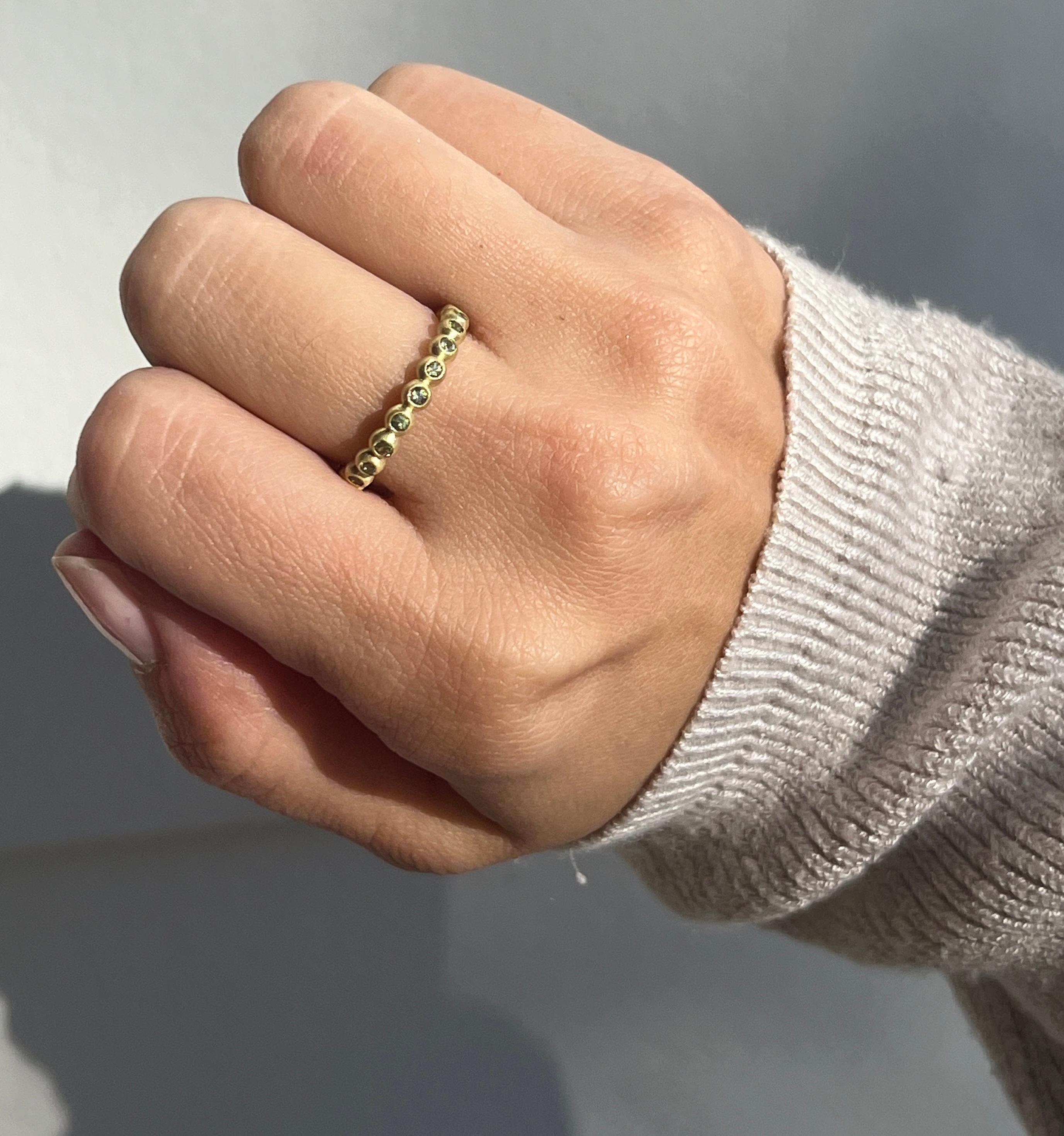 Faye Kim's brilliant Green Sapphire Granulation Bead Ring is handcrafted in 18 karat gold and matte finished for a contemporary look. Wear alone or stacked with others to express your own unique style. 

Green Sapphire .40 Carats twt
Band width