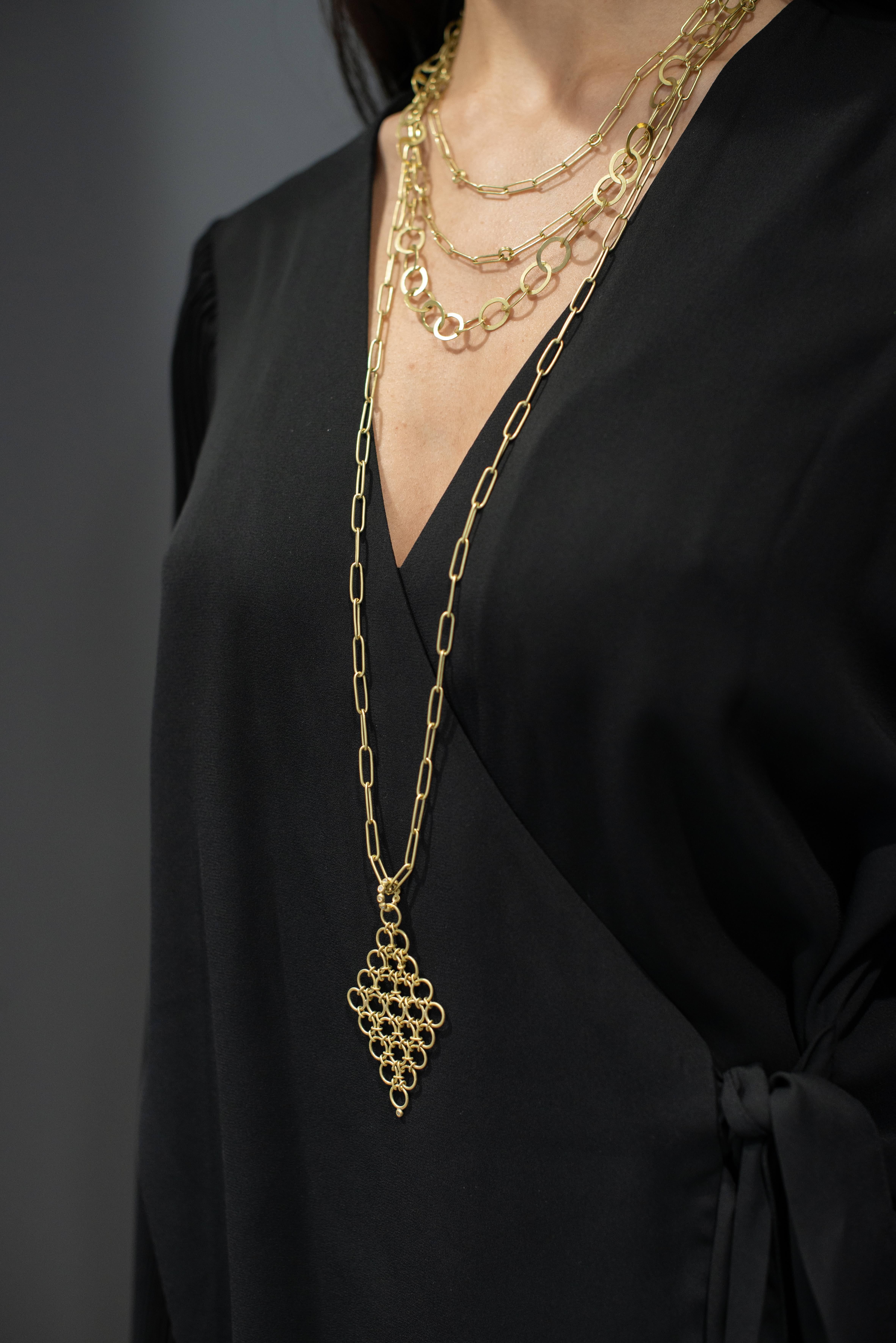 Faye Kim 18K Gold Handmade Diamond Mesh Pendant on Handmade Chain.

18k gold mesh pendant is handmade of flexible links. Finished with a diamond granulation bail and tip - it's the little details that make this pendant a statement piece. Featured on
