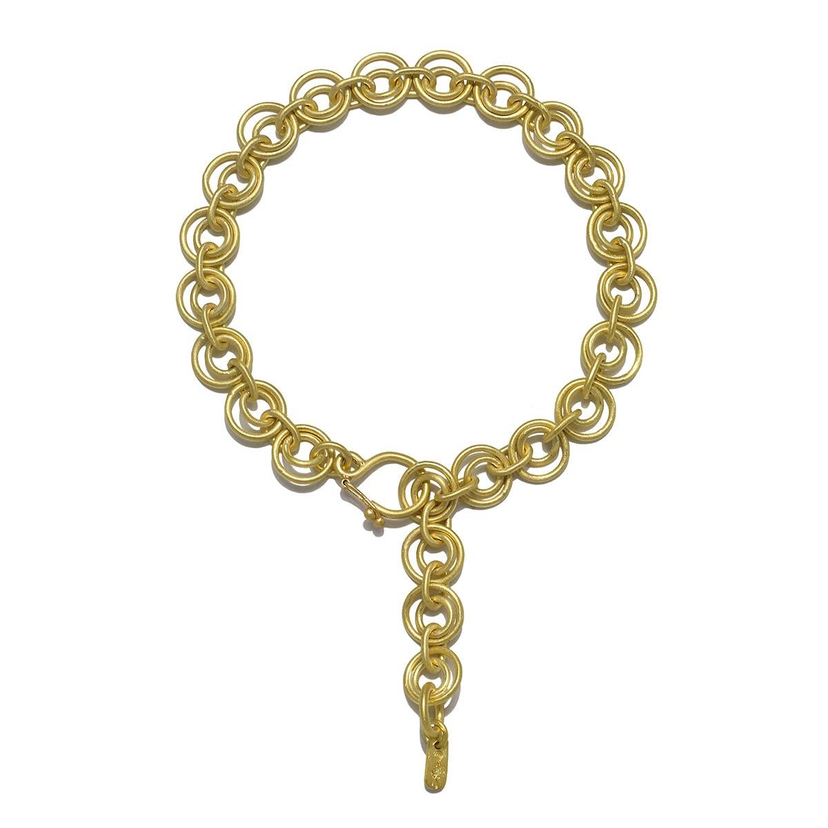 
Faye Kim's 18k Gold Handmade Double Loop Chain Bracelet, in her signature green gold matte finish, is a striking statement piece that is adjustable in length and can be worn on its own, together with a charm suspended from it, or layered with other