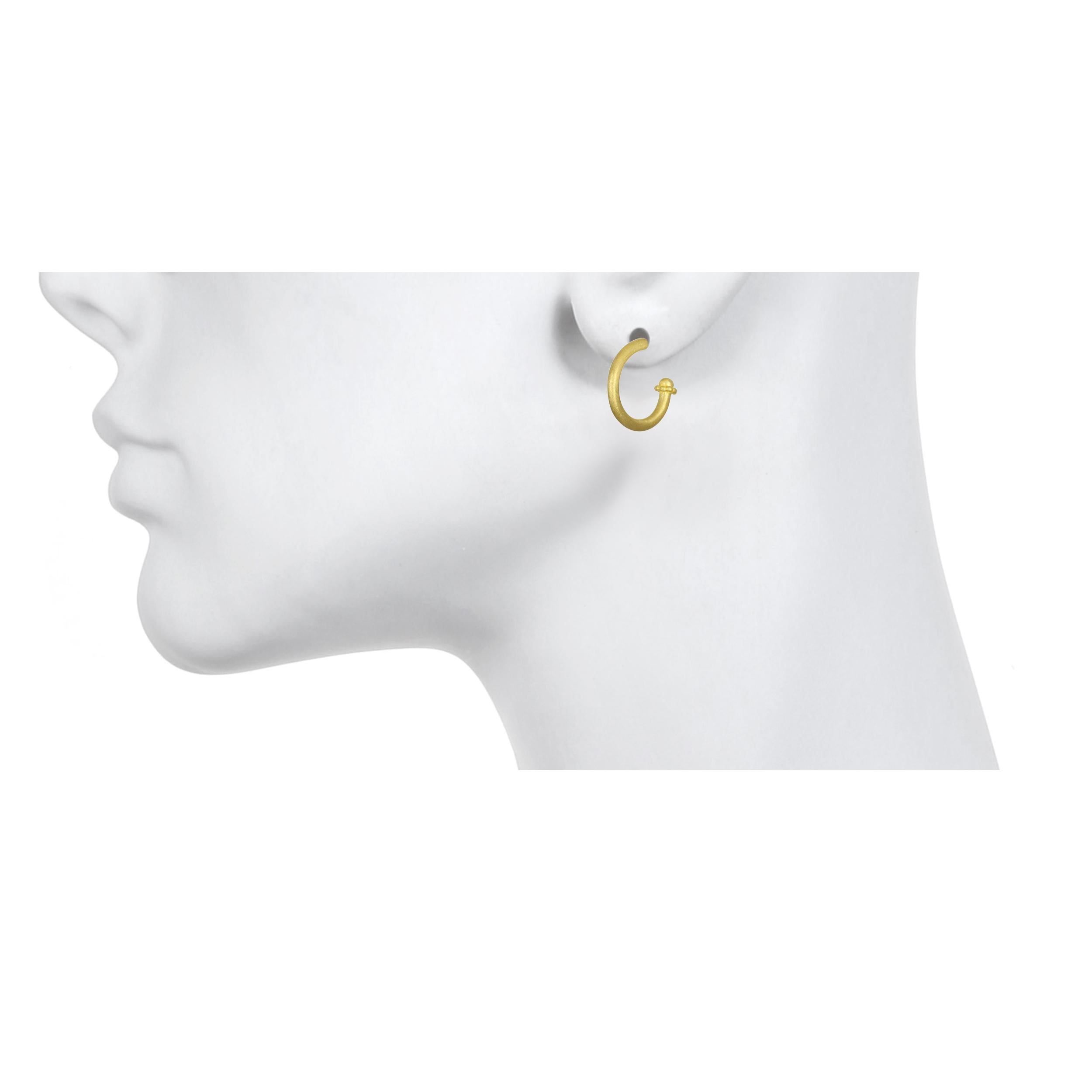 Handcrafted in 18k gold, Faye Kim’s modern post hoop design, with its granulation tip detailing, conveys understated elegance and a truly stylish, everyday look. Solid with a matte finish and post backs, these hoops are easy to wear and can be