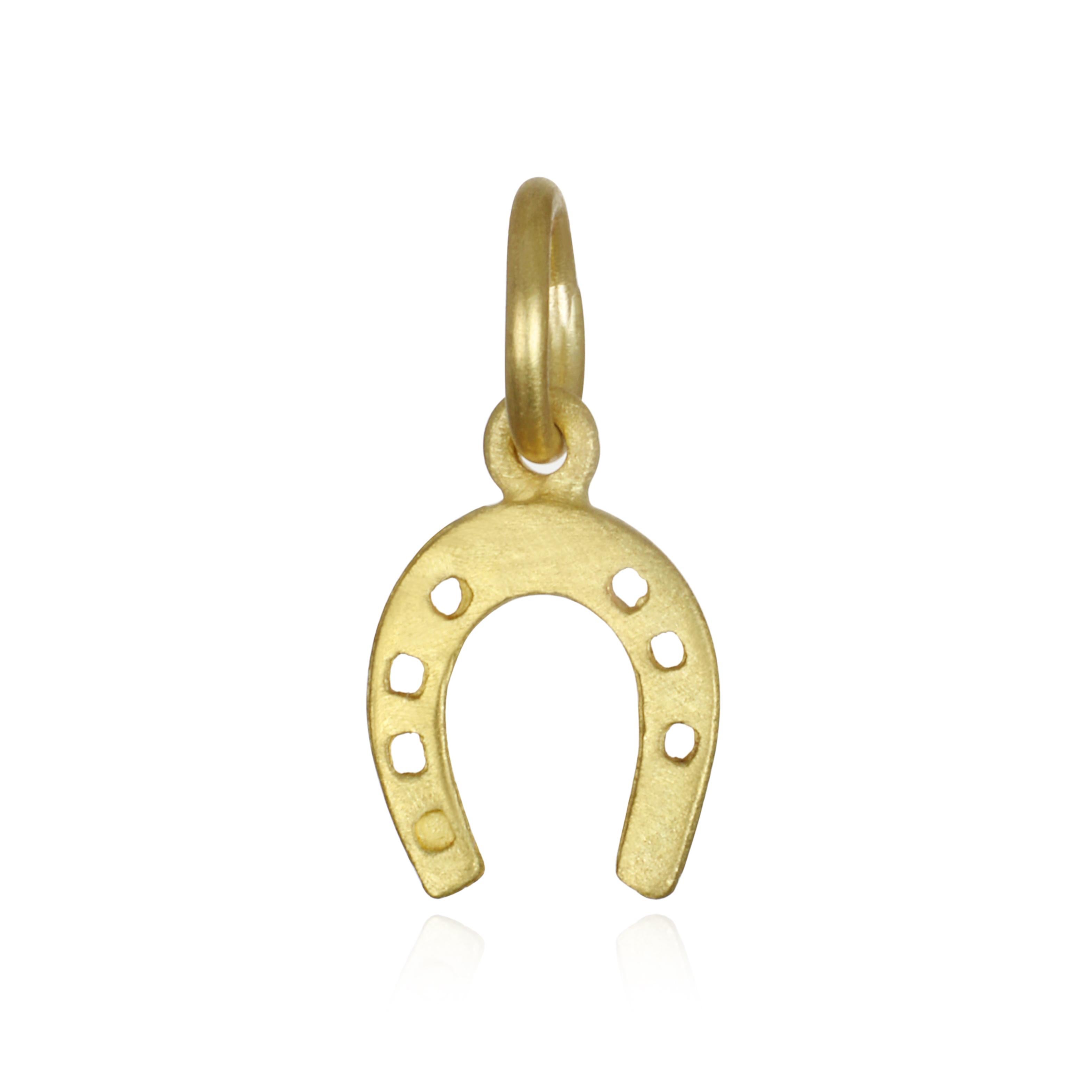 Believed to keep evil spirits out and bring good fortune in, the mini horseshoe charm is a symbol of good luck and protection. 
Charm Length: 10mm 
Chain: 16