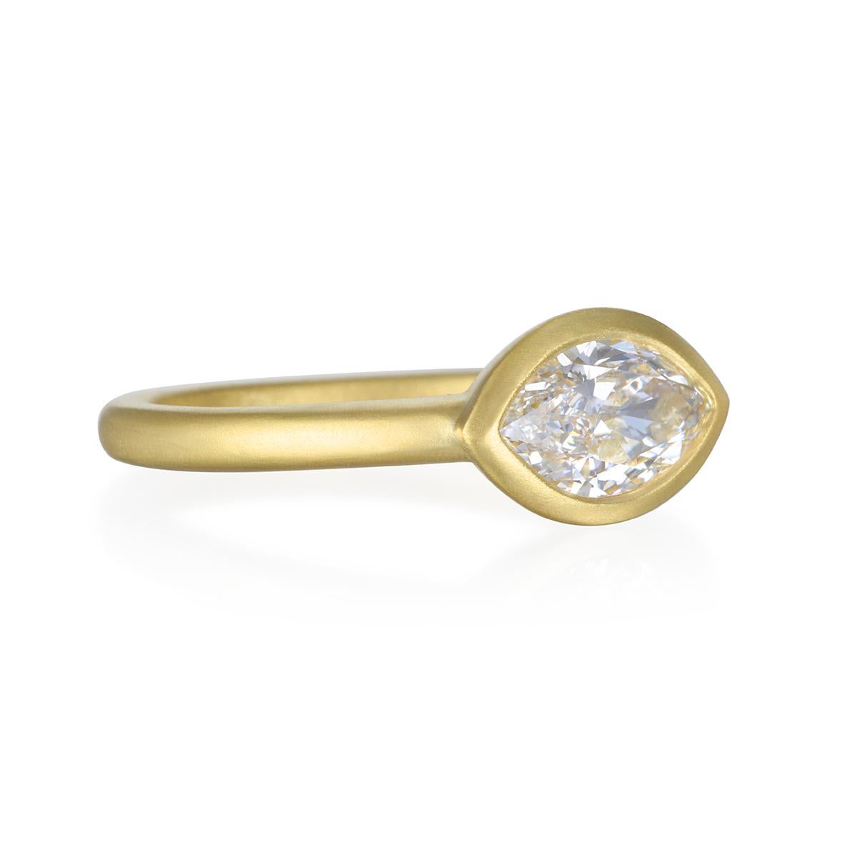 Make an impact with this dazzling modern marquise cut diamond ring. Perfect for stacking or for the modern bride.  Express your individuality with an original design  
handcrafted in 18k gold with a unique east-west bezel setting to highlight the