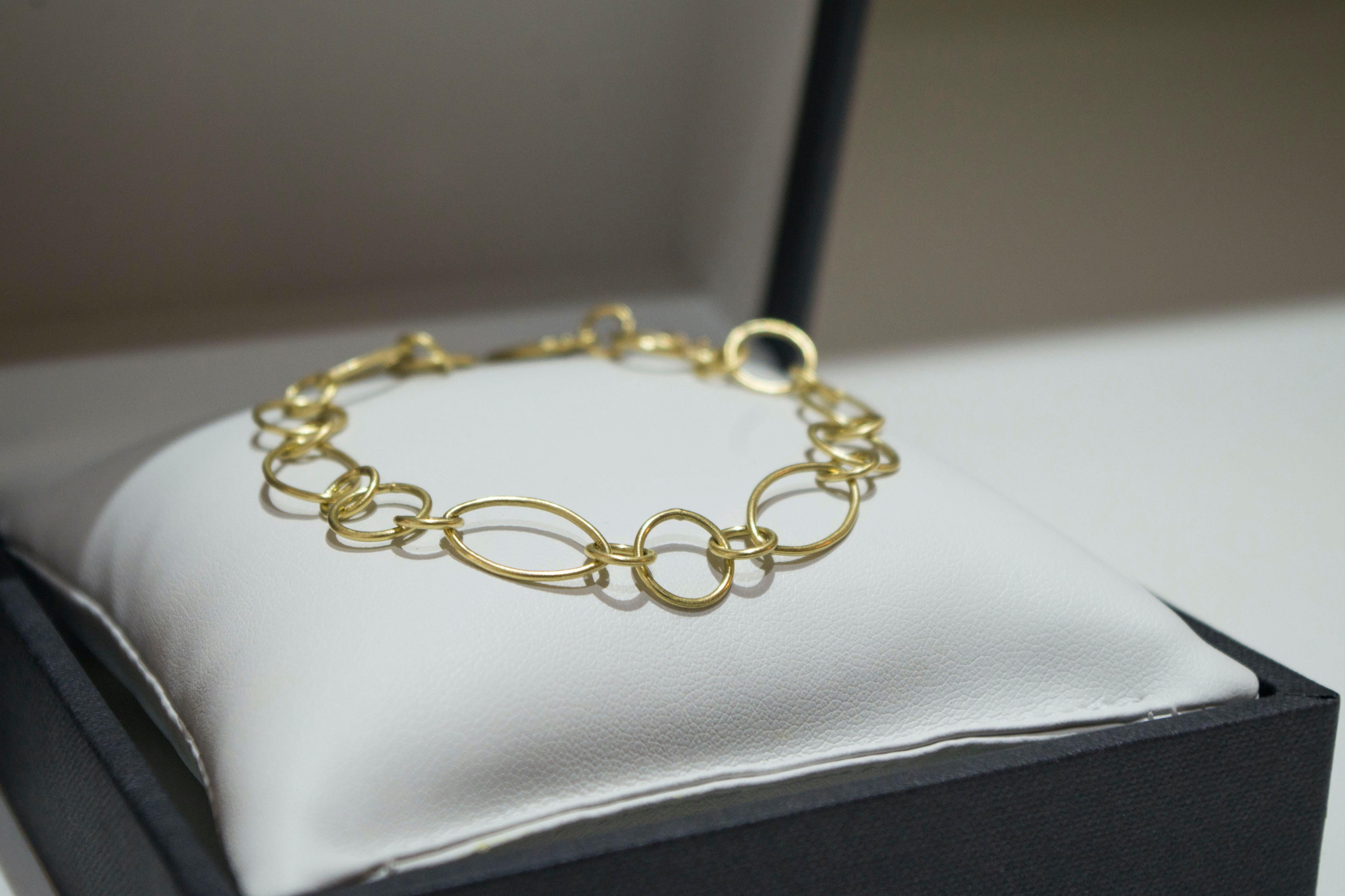 Faye Kim's 18 Karat Gold open link handcrafted bracelet is handcrafted with mixed shapes and sizes.
Matte finished, with a safety hook. Personalize it with your own charms or choose from our selection.

Length: 7