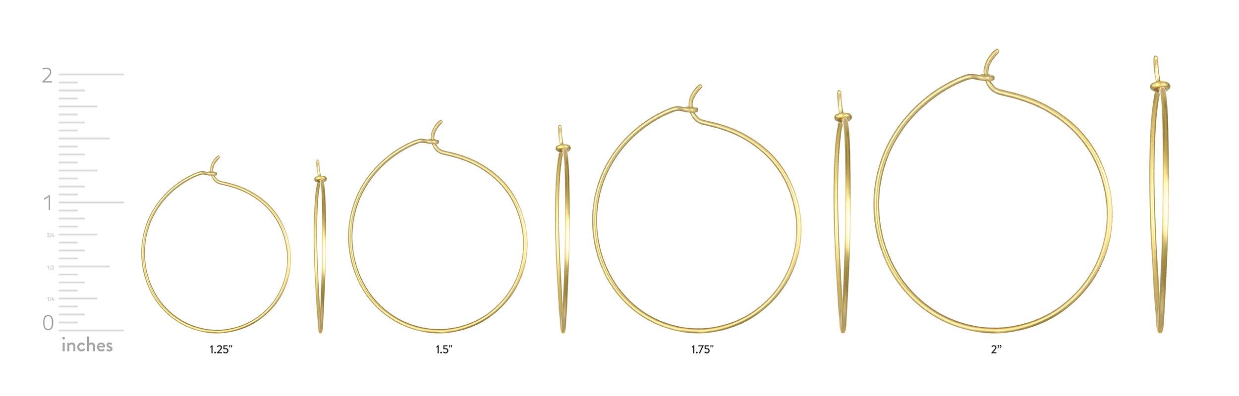 Faye Kim's 18 Karat Gold Moon and Star charms shine brightly from these classic, wire hoops.  Charms are removable.

Length of Charms:  8-10mm

Wire Hoops:  1.75