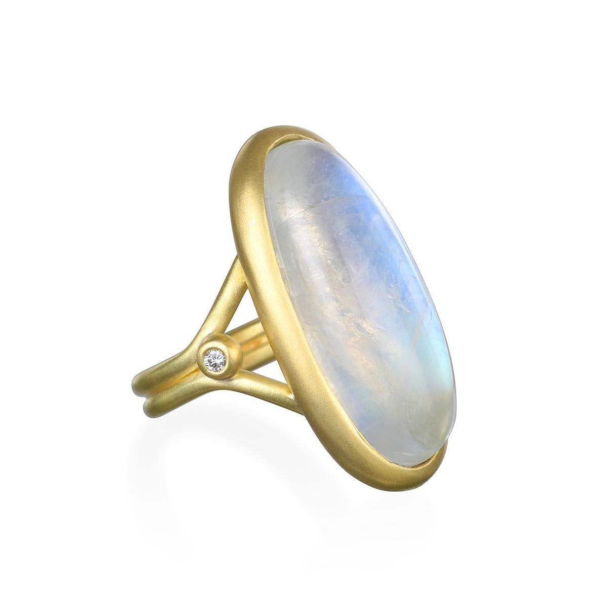 Considered to be a stone of inner growth and strength, this round rainbow moonstone with its two side diamonds has been set by designer Faye Kim in 18K gold* and reflects a bluish, milky light that has been compared to the light of the moon. The