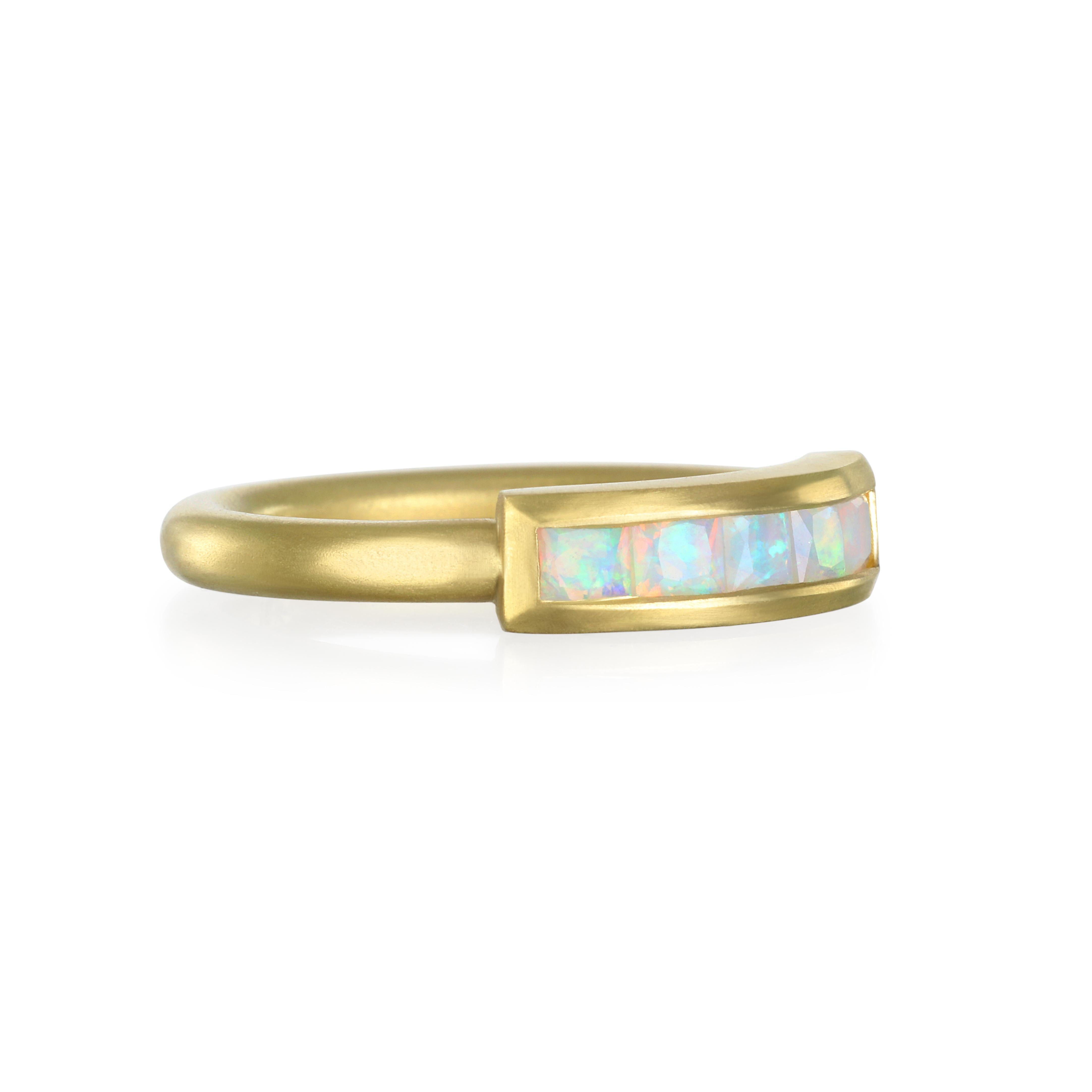Faye Kim's 18 Karat Gold Opal Channel-Set Bar Ring features a display of dazzling color mixed with brightness, shimmer, and just the right amount of sparkle. Channel set and matte finished, this piece can be worn alone or statcked with other rings