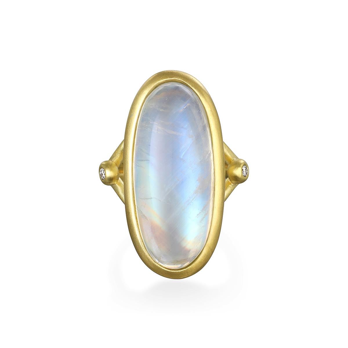 Considered to be a stone of inner growth and strength, this round rainbow moonstone with its two side diamonds has been set by designer Faye Kim in 18K gold and reflects a bluish, milky light that has been compared to the light of the moon. The