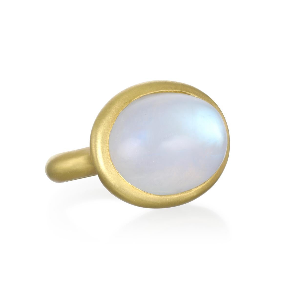 Considered to be a stone of inner growth and strength, this mesmerizing rainbow moonstone has been bezel set by designer Faye Kim in 18k gold and reflects a bluish, milky light that has been compared to the light of the moon. The shape, polish, and