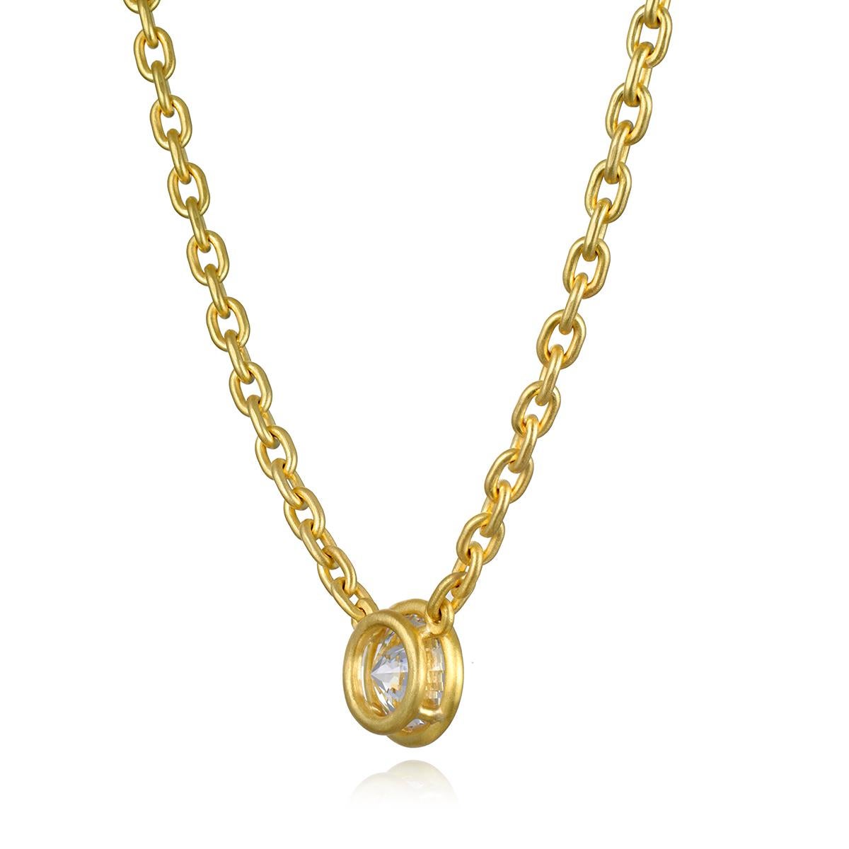 Faye Kim has set this spectacular 4+ carat round brilliant cut Diamond into a perfectly balanced bezel and chain necklace. Handmade in chunky 18 karat gold, the mini oval link chain is the perfect complement to showcase the center diamond. ideal for