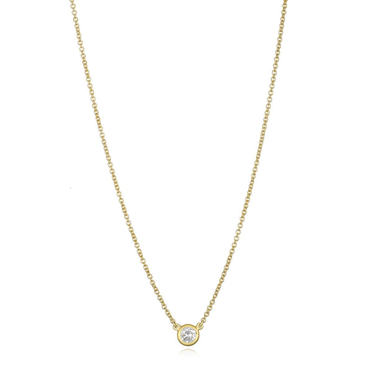 Set in 18 karat gold, the solitaire diamond necklace features a sparkling round brilliant cut diamond in a thin clean bezel. Wear alone or layered for a look that is timeless and perfect for every day.  

Total length 16